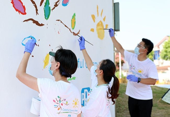 volunteers painting mural