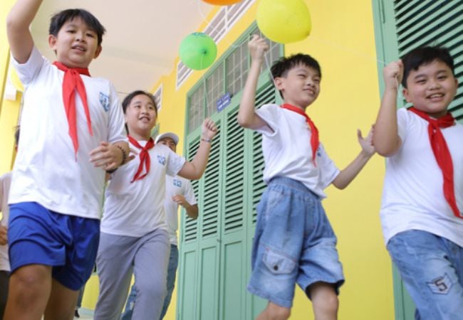 boys running past painted wall