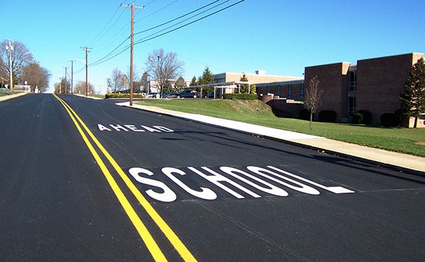 HotTape® Preformed Thermoplastic used to spell School Ahead on a roadway