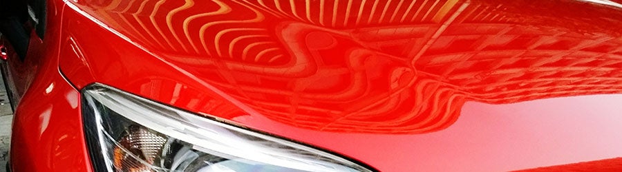 Close-p of car to show the reflections on a clearcoat paint