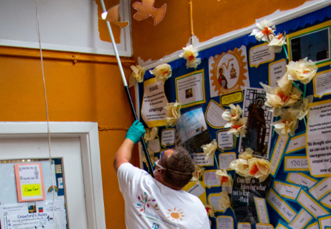 Guy hanging paper birds 