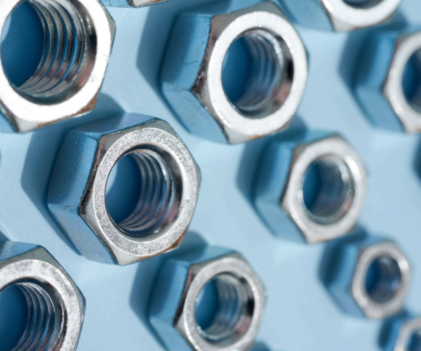 Silver nuts lying on a metal surface