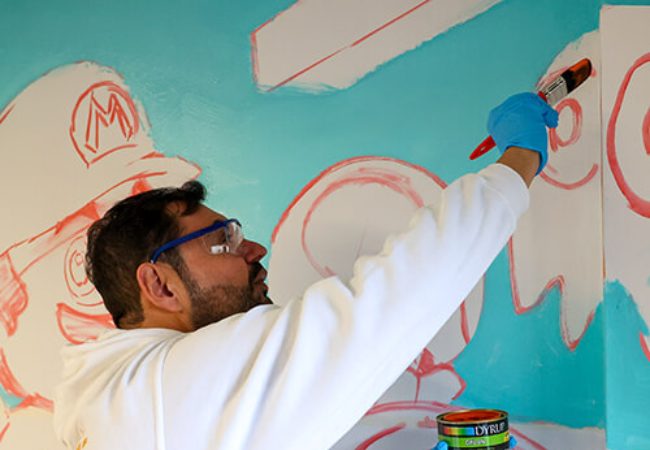 man painting wall mural in Porto (Rio Tinto), Portugal