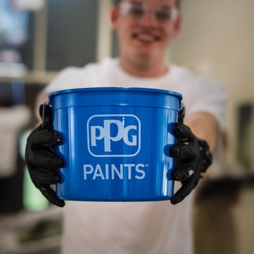 man holding PPG Paints bucket 