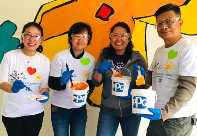 four volunteers painting