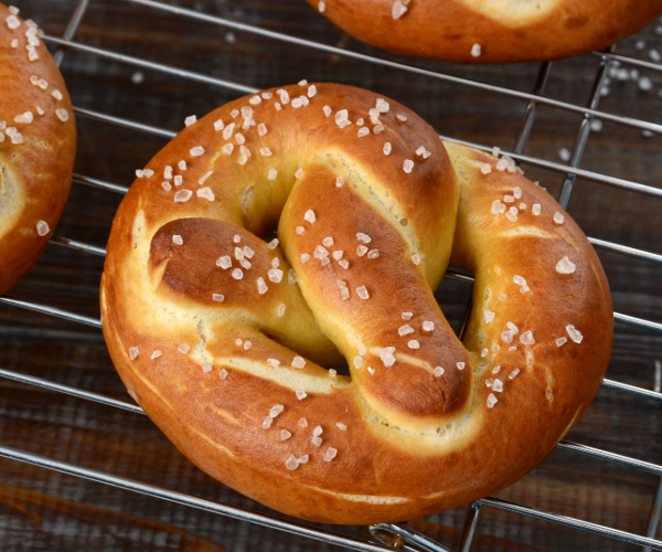 Salted baked pretzels on a metal grill