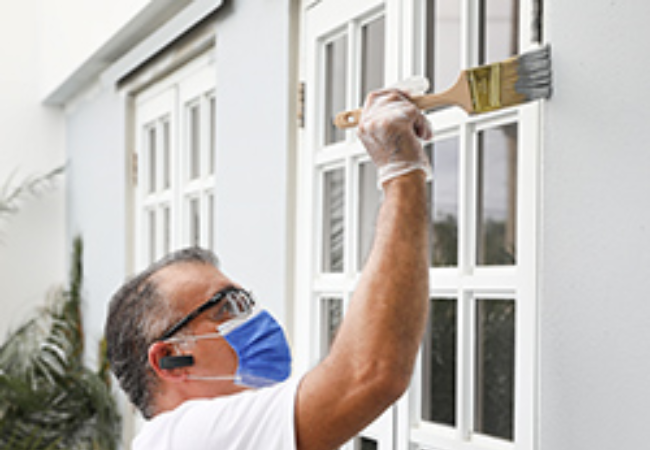 man painting wall grey 