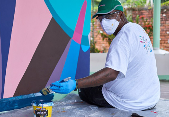 man painting wall mural 