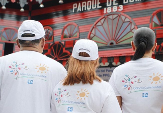 volunteers' back of t-shirt featuring colorful communities PPG logo 