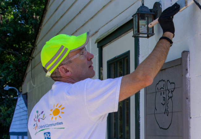 man painting wall white