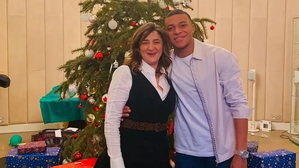 Kylian Mbappé poses by his mother's side.