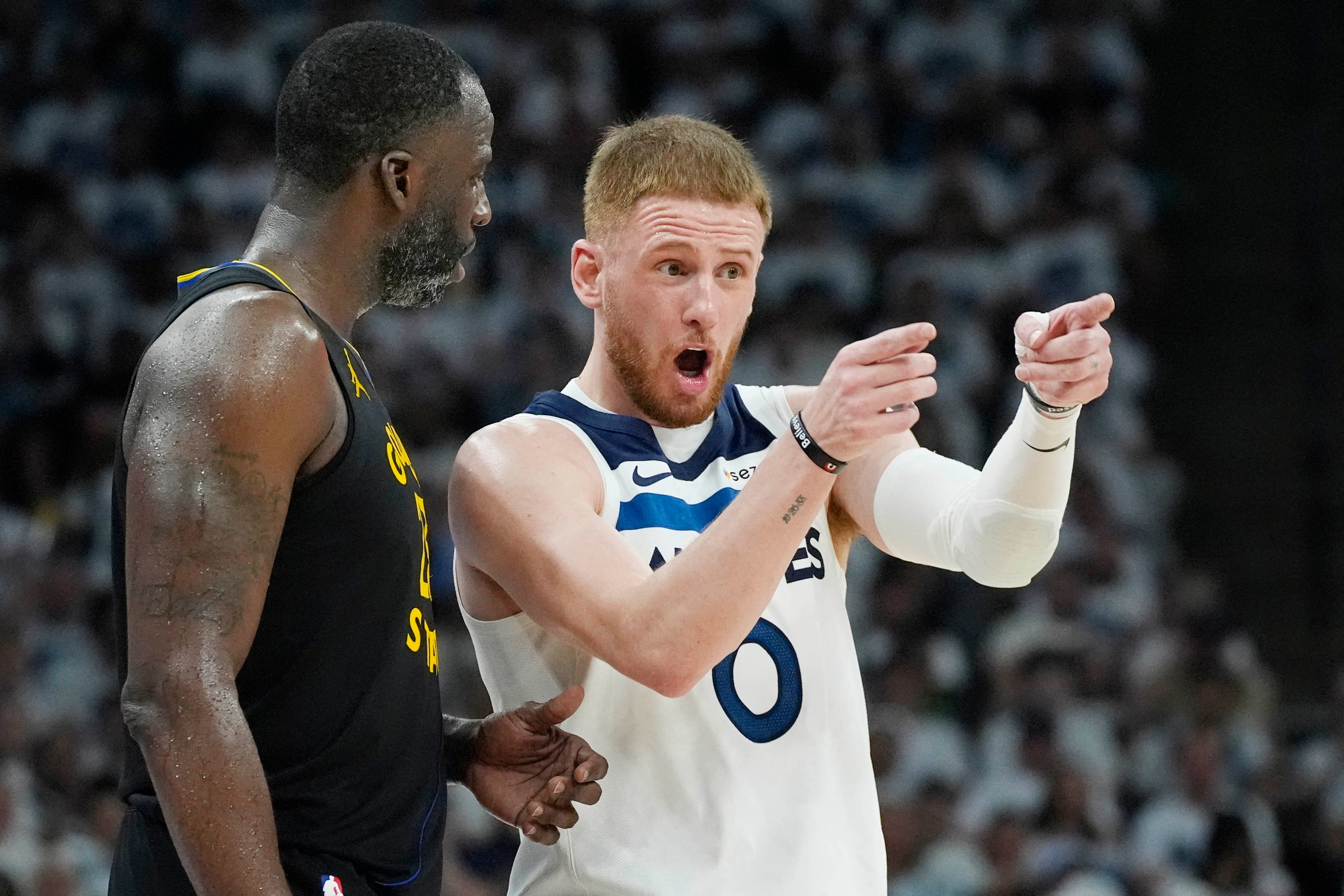 Minnesota Timberwolves' Donte DiVincenzo with Golden State Warriors' Draymond Green in 2025 NBA Playoffs.