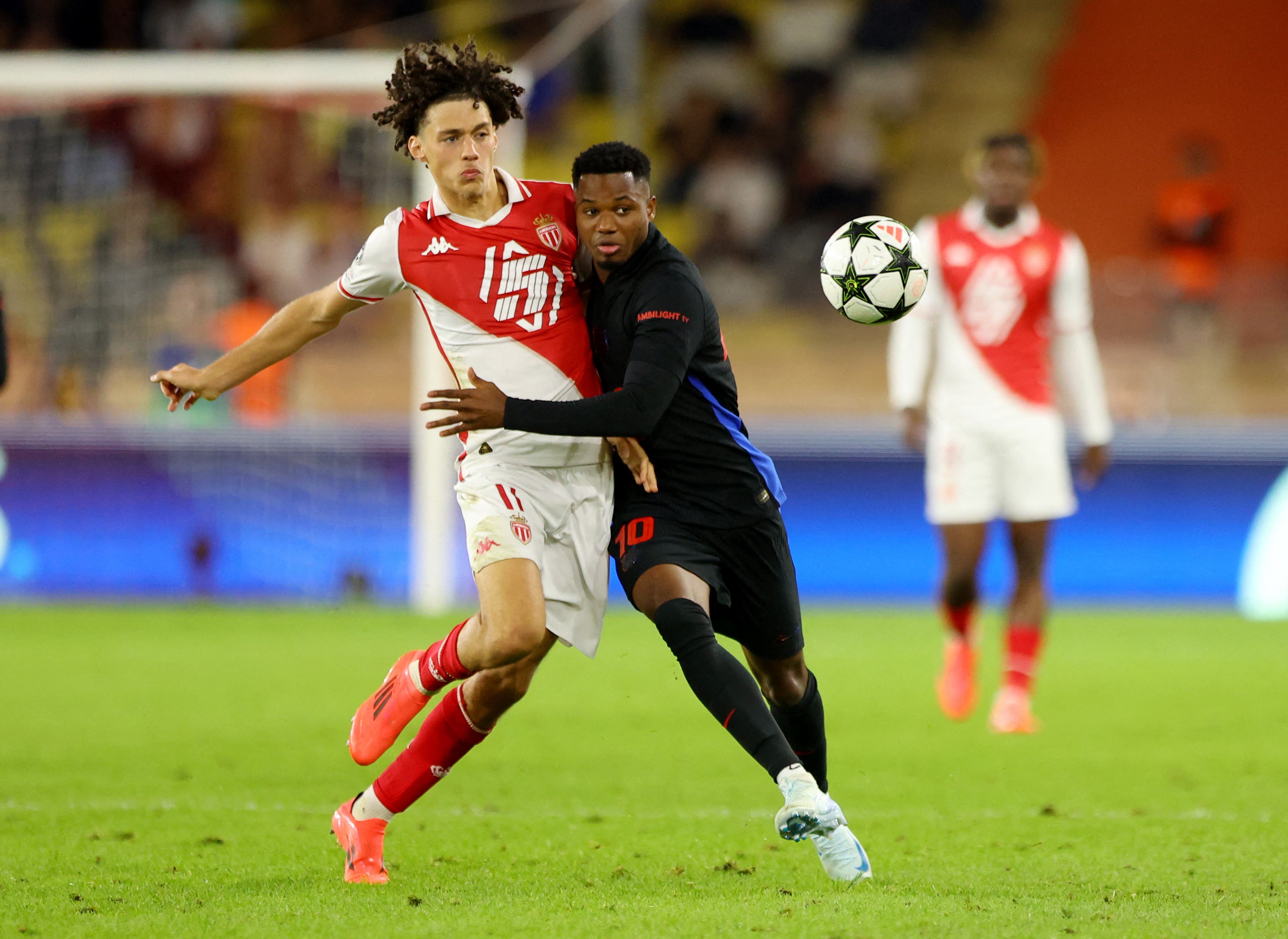 AS Monaco's Maghnes Akliouche in action with FC Barcelona's Ansu Fati 