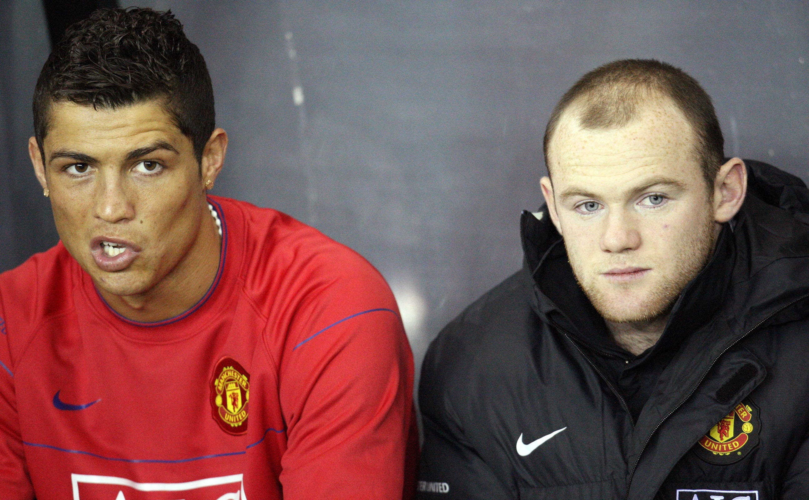 Cristiano Ronaldo and Wayne Rooney sitting on Manchester United bench.