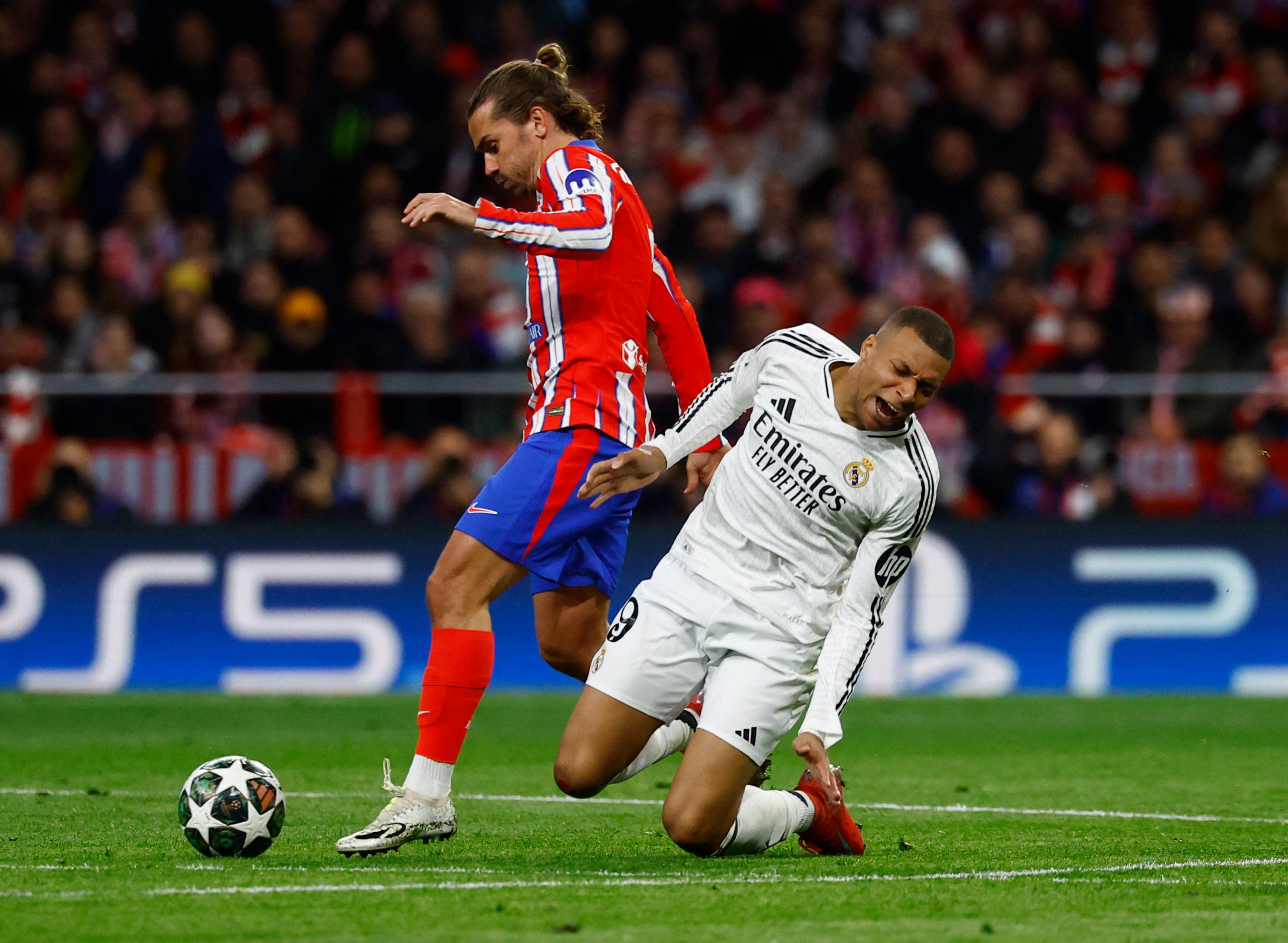 Atletico Madrid's Antoine Griezmann in action with Real Madrid's Kylian Mbappe