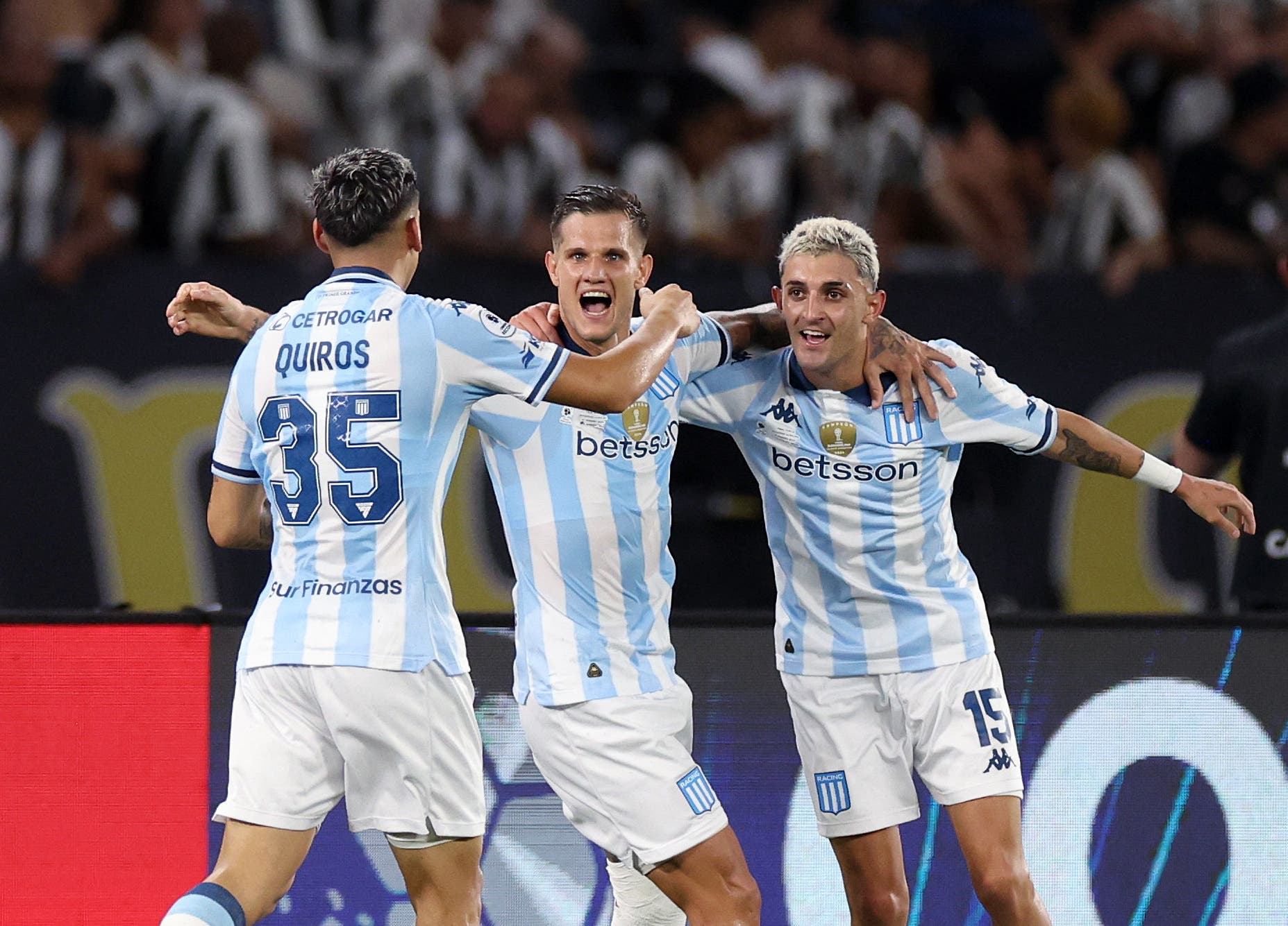 Racing Club's Bruno Zuculini celebrates scoring their second goal with Santiago Quiros and Gaston Martirena 