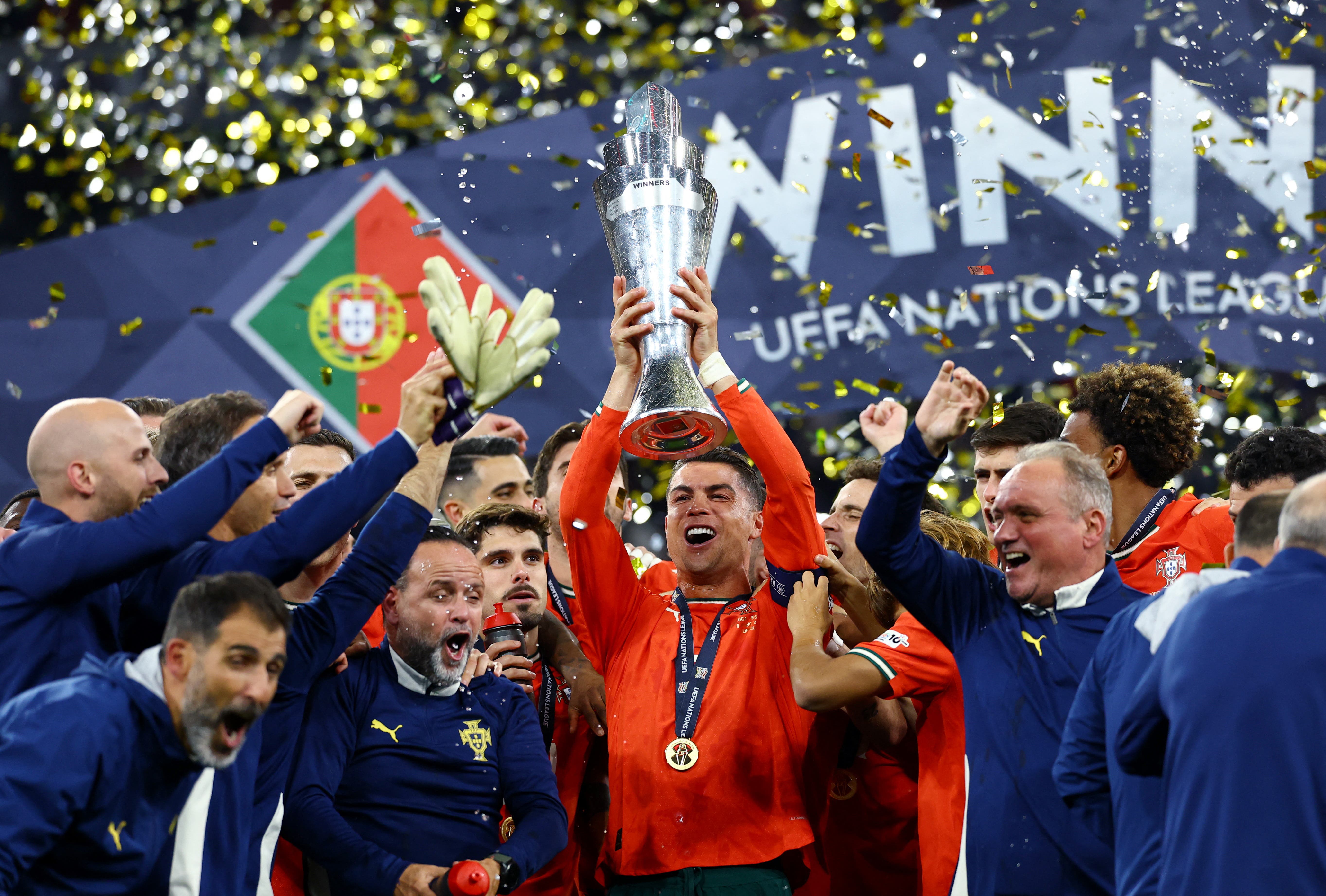 Portugal's Cristiano Ronaldo lifts the trophy as he celebrates with teammates after winning the Nations League