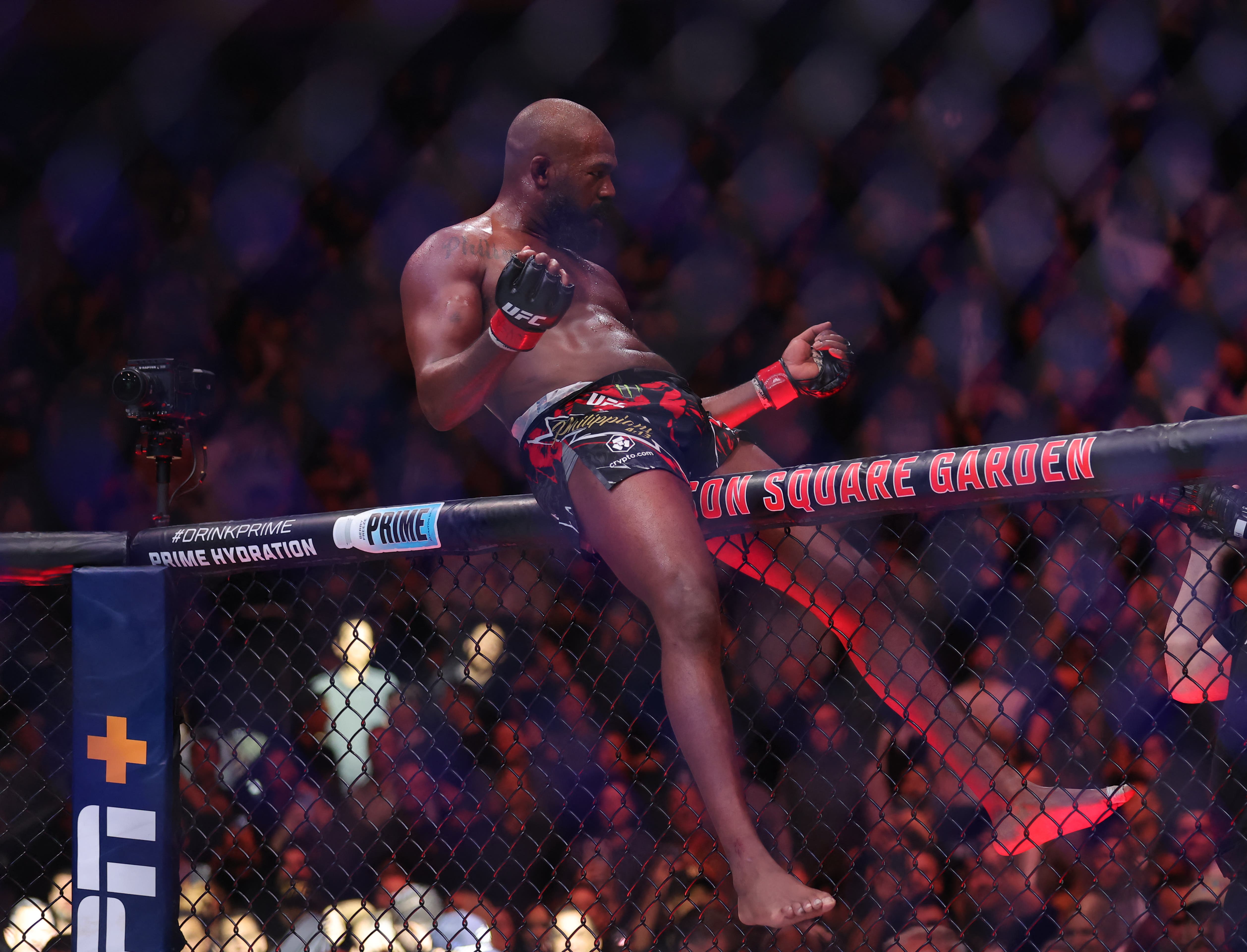 Nov 16, 2024; New York, NY, USA; Jon Jones (red gloves) celebrates defeating Stipe Miocoic (blue gloves) in the heavyweight bout during UFC 309 at Madison Square Garden. Mandatory Credit: Brad Penner-Imagn Images