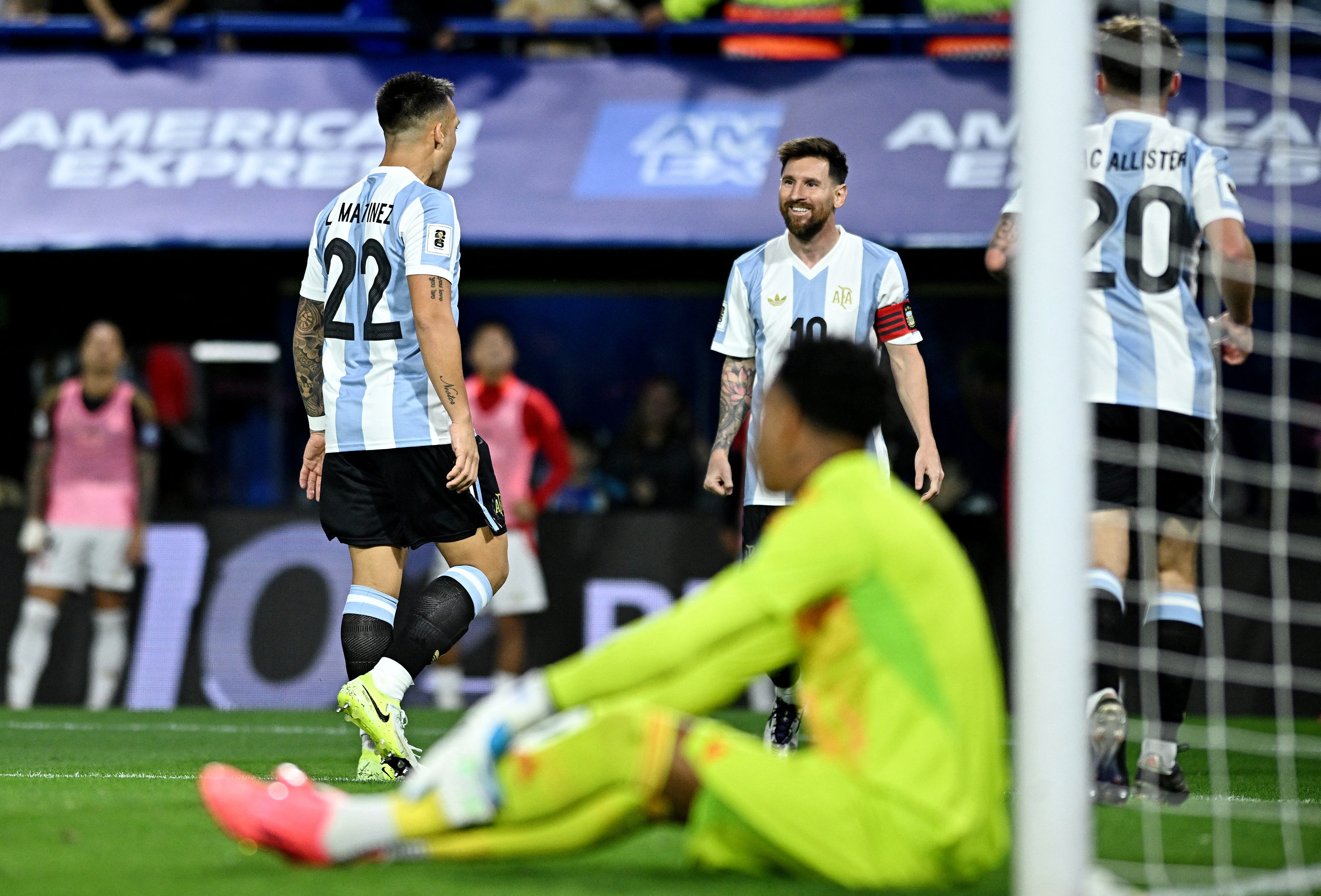 Argentina's Lautaro Martinez celebrates scoring their first goal with Lionel Messi 