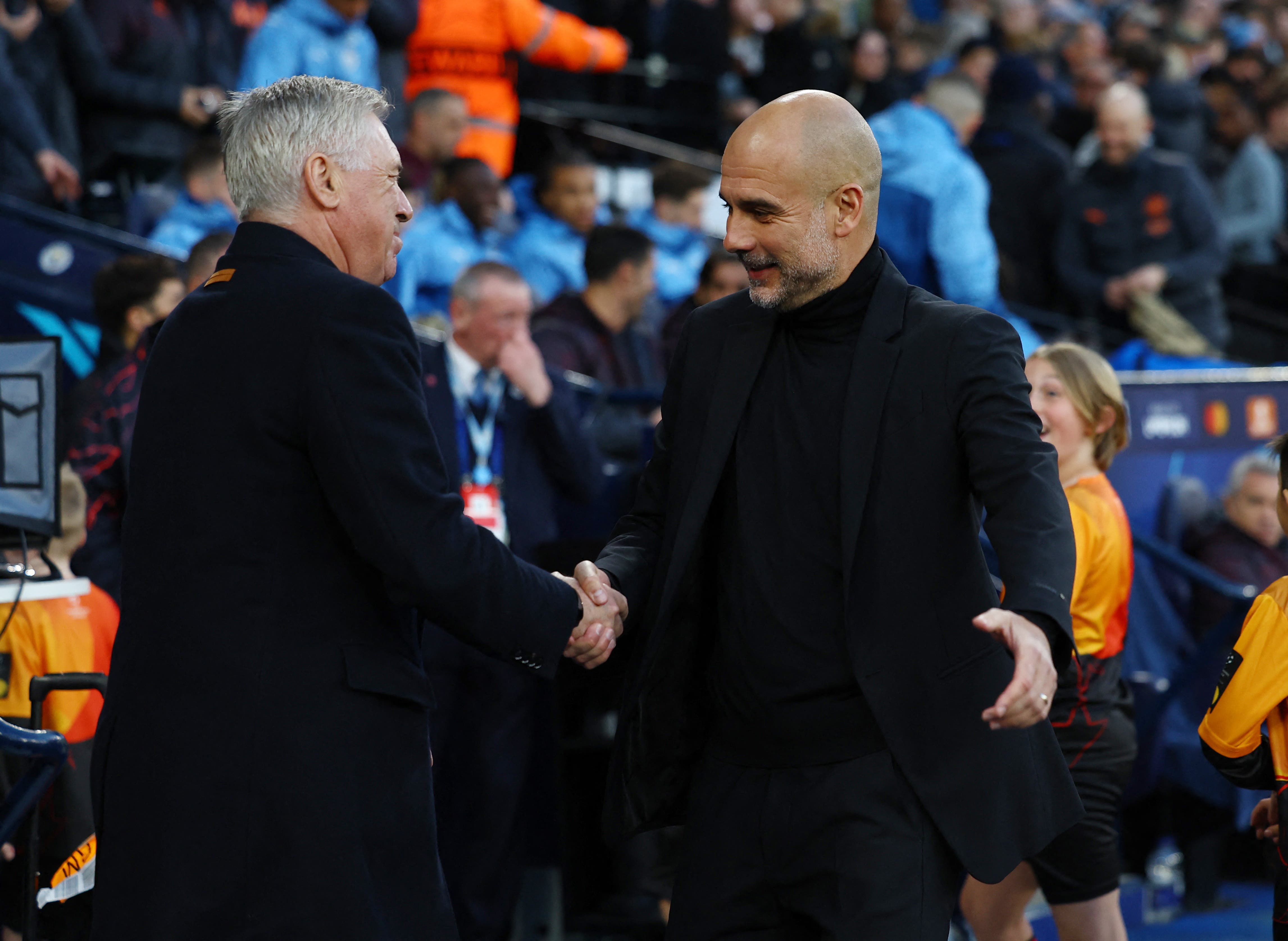 Manchester City manager Pep Guardiola shakes hands with Real Madrid coach Carlo Ancelotti before the match