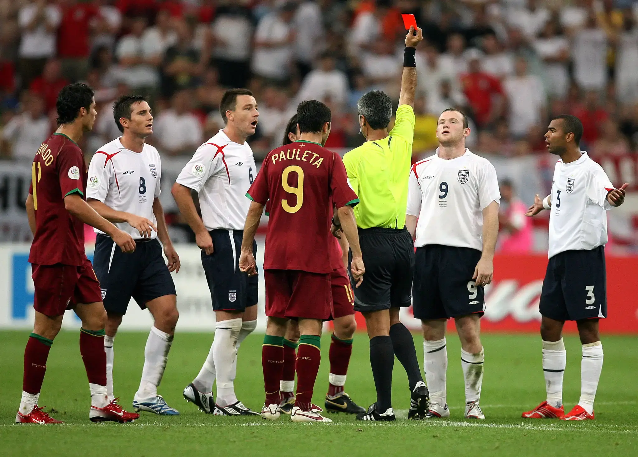 Wayne Rooney is shown a red car by the referee of the match between Portugal and England on 2006.