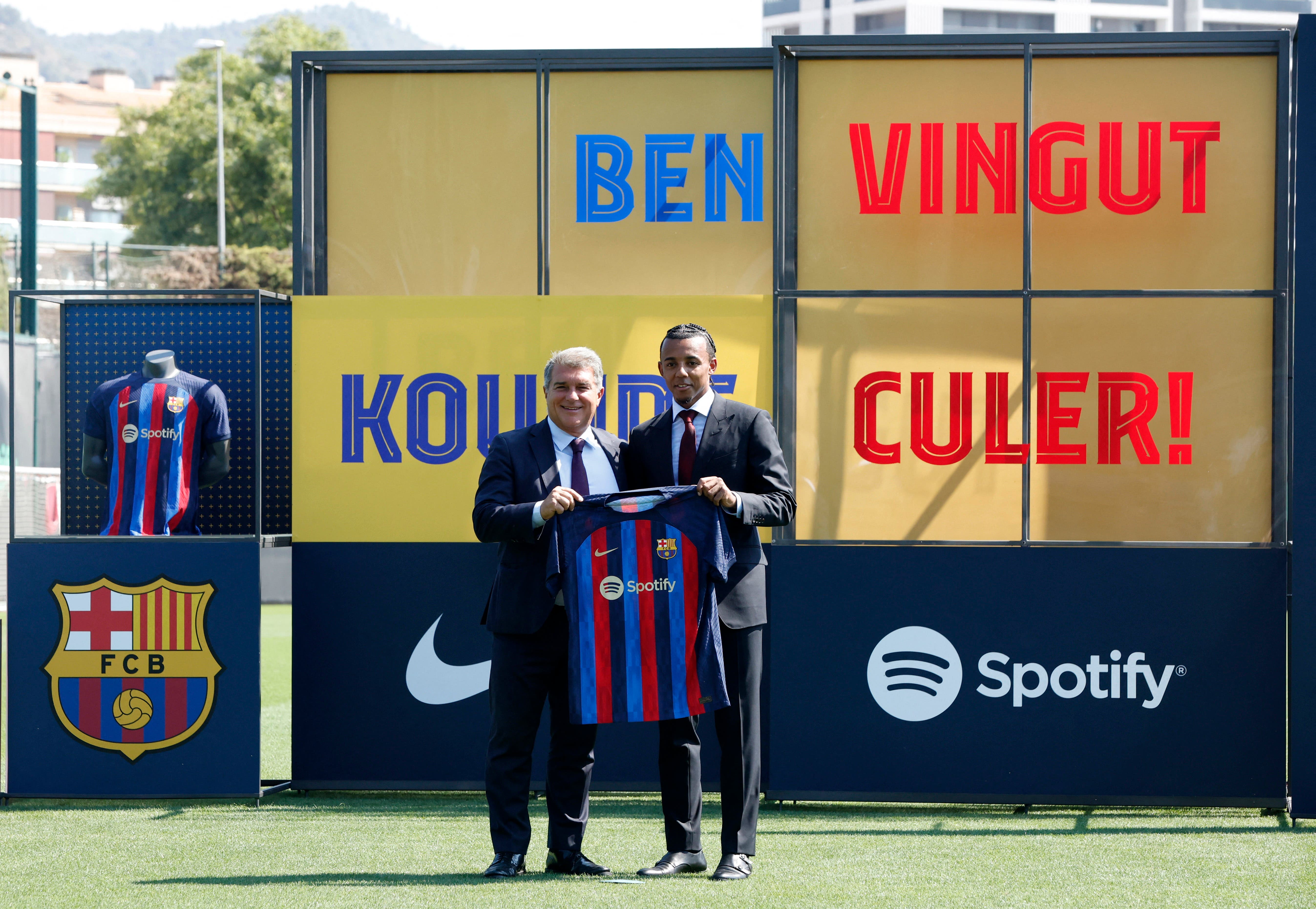 C Barcelona President Joan Laporta and new player Jules Kounde pose for a picture with the club shirt during the unveiling 