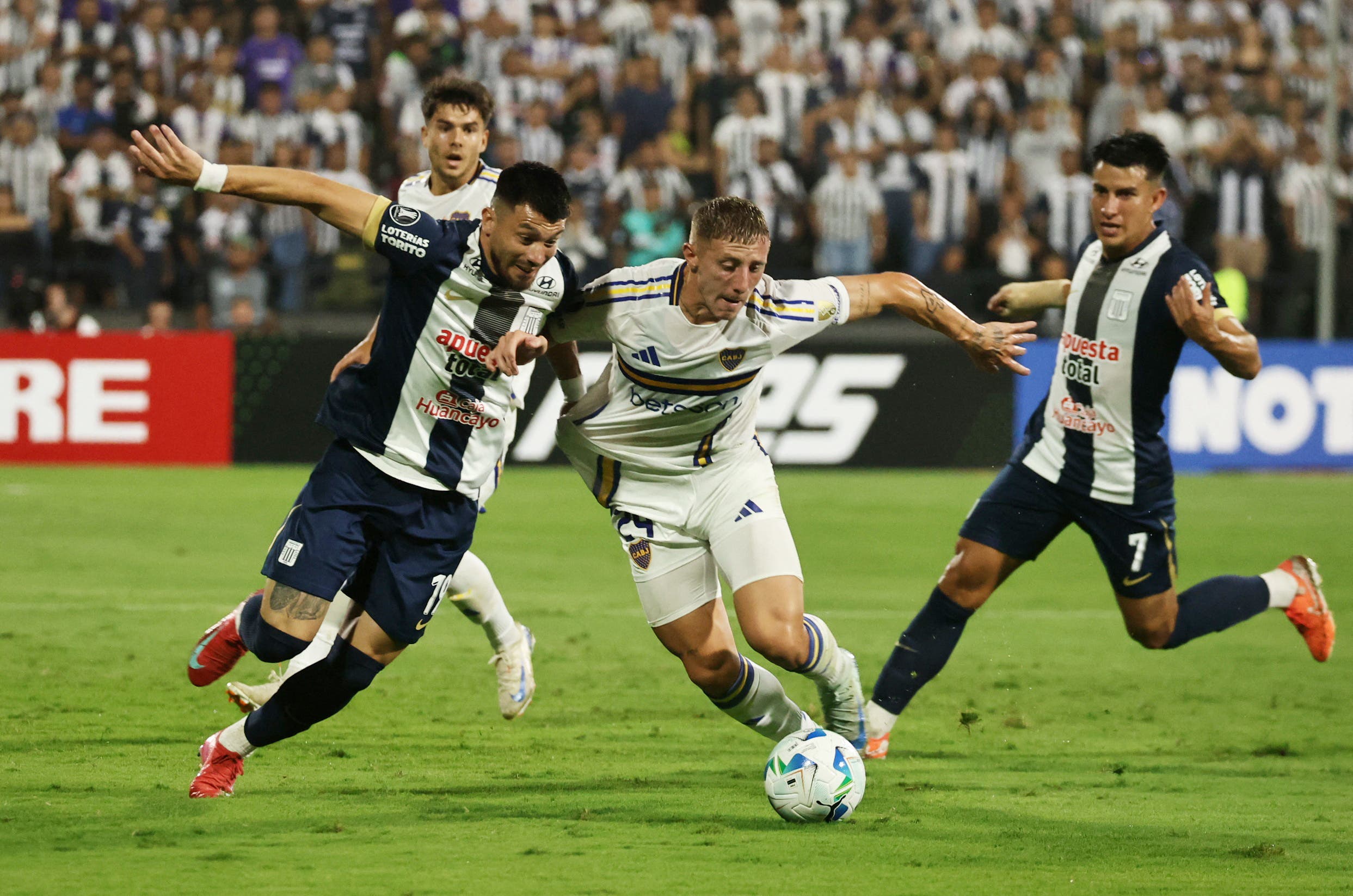 Alianza Lima's Alan Cantero in action with Boca Juniors' Juan Barinaga