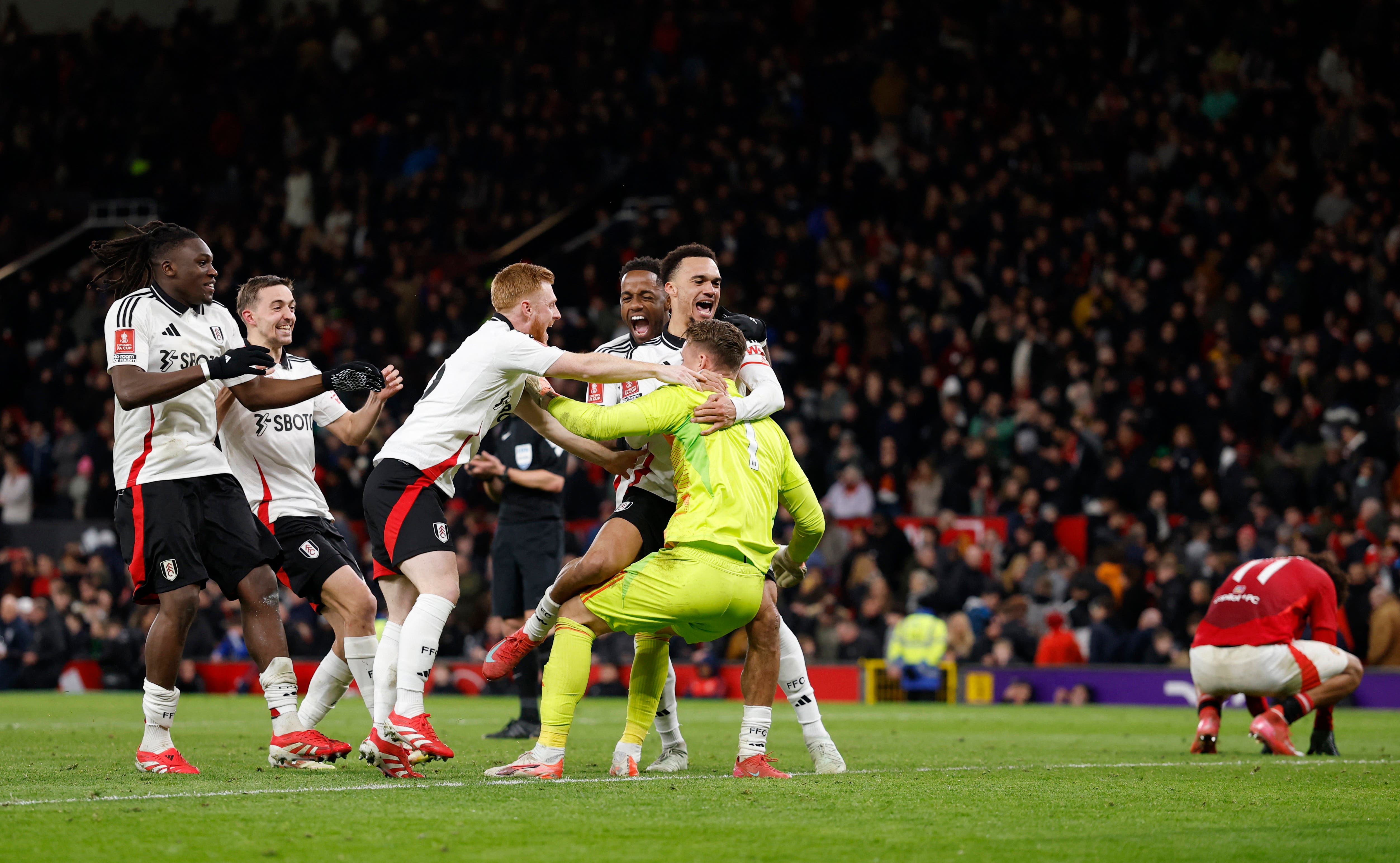 Fulham's Bernd Leno celebrates with his team mates after he saves the penalty from Manchester United's Joshua Zirkzee to win the penalty shoot-out