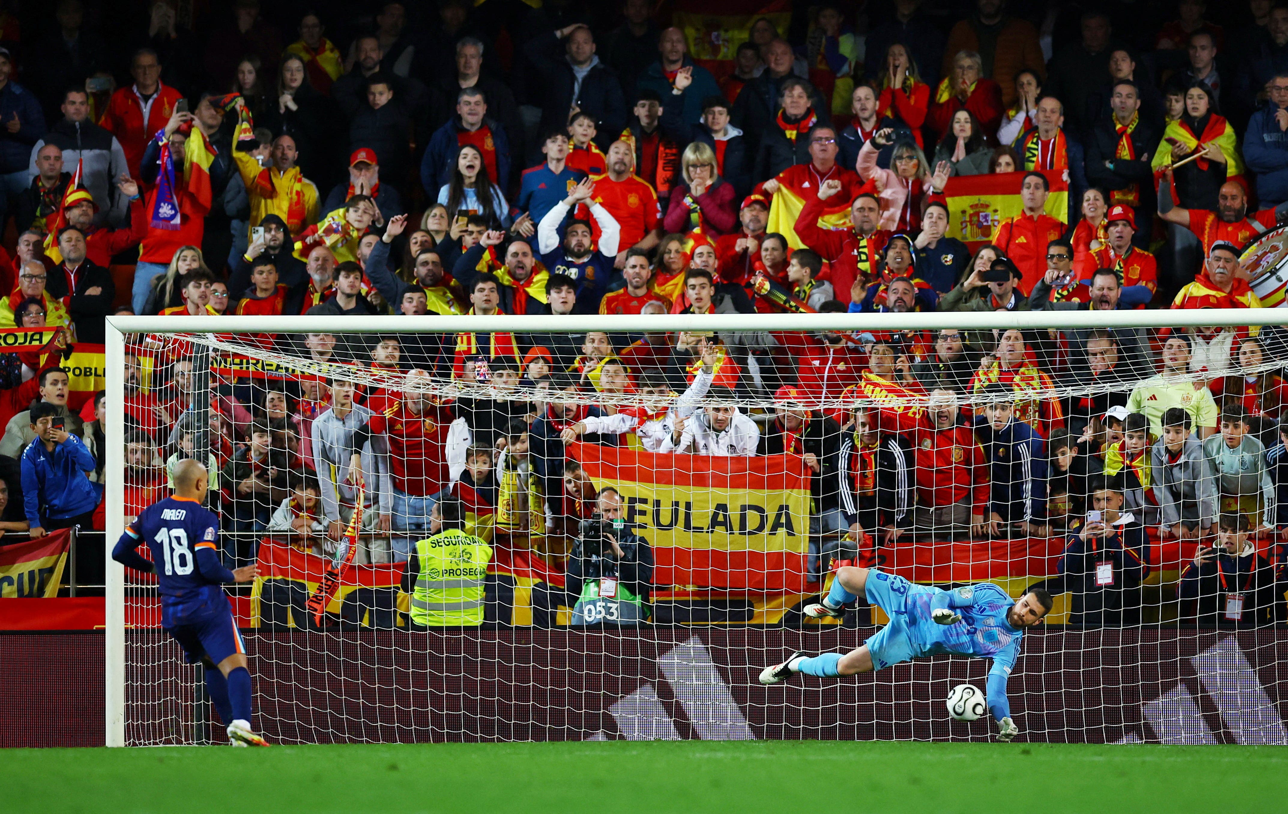 Spain's Unai Simon saves a penalty from Netherlands' Donyell Malen during the penalty shootout 