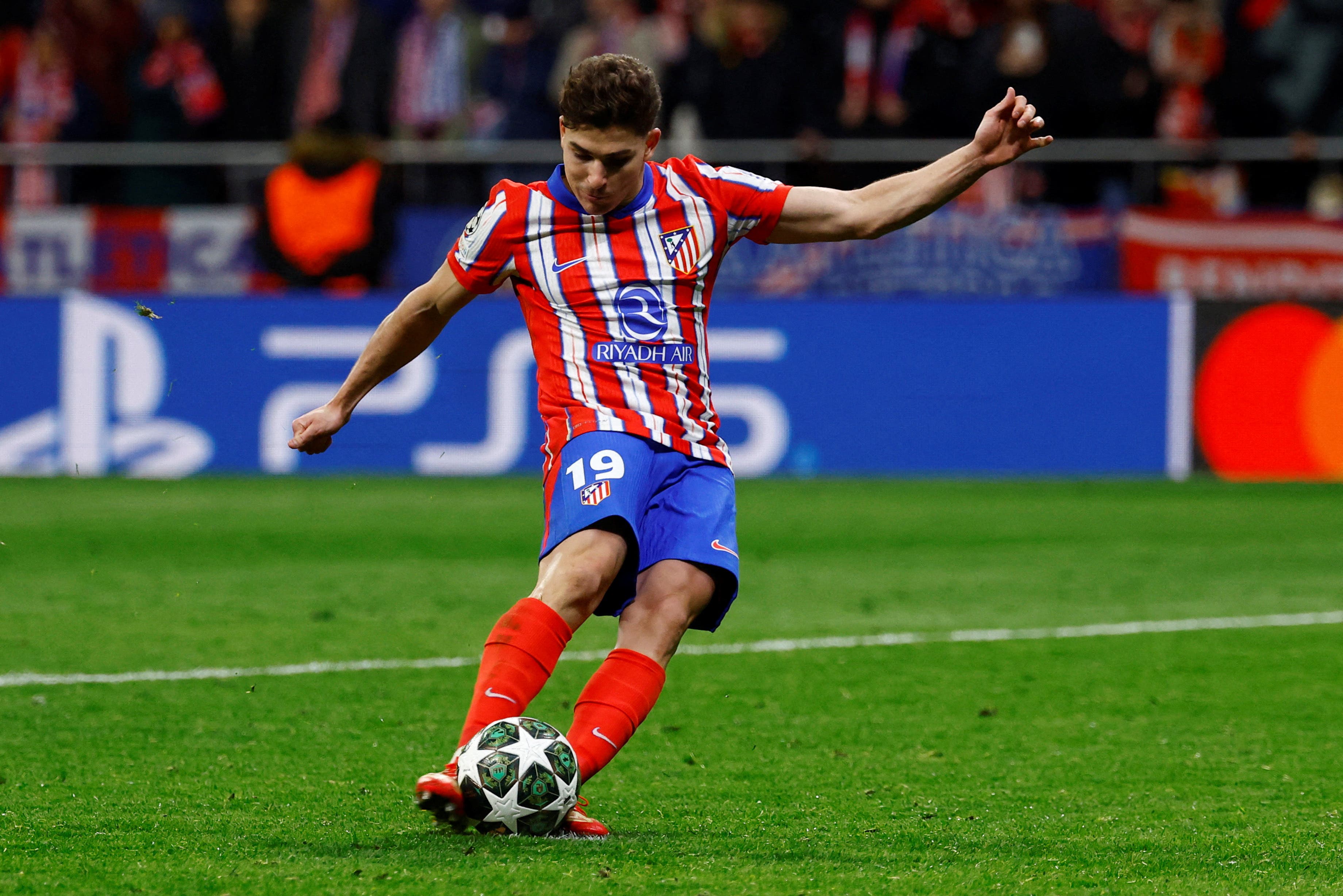 Atletico Madrid's Julian Alvarez scores a penalty during the penalty shootout wich is later disallowed after a VAR review