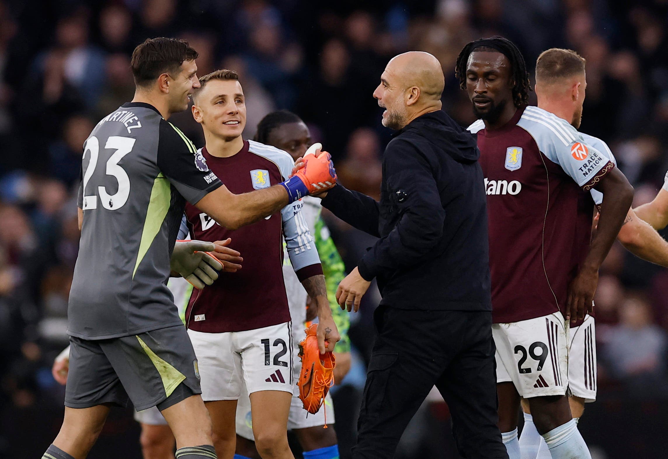 Soccer Football - Premier League - Aston Villa v Manchester City - Villa Park, Birmingham, Britain - October 26, 2025 Aston Villa's Emiliano Martinez shakes hands with Manchester City manager Pep Guardiola after the match Action Images via Reuters/Andrew Couldridge