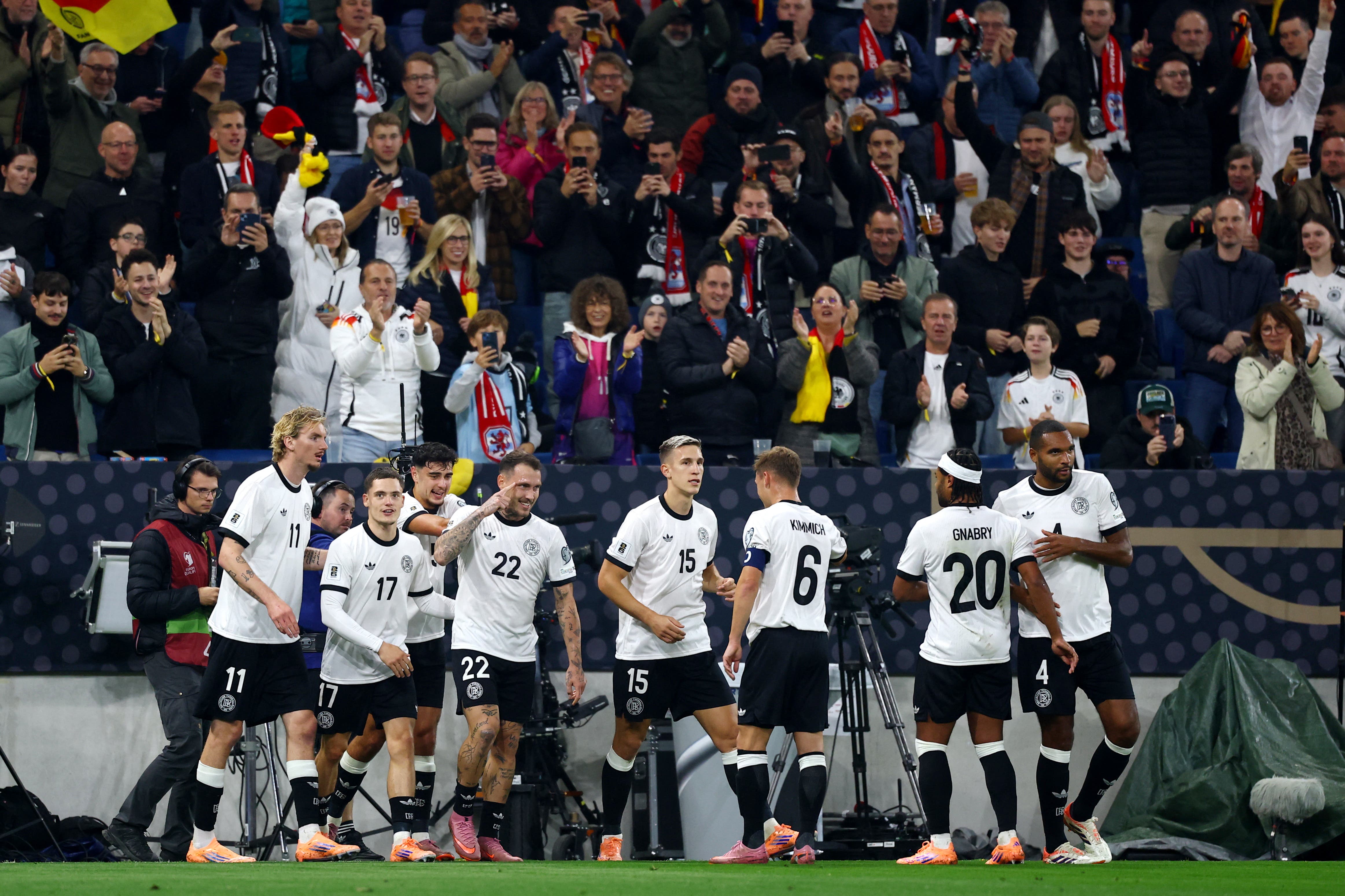 Soccer Football - FIFA World Cup - UEFA Qualifiers - Group A - Germany v Luxembourg - Rhein-Neckar-Arena, Sinsheim, Germany - October 10, 2025 Germany's David Raum celebrates scoring their first goal with teammates REUTERS/Kai Pfaffenbach
