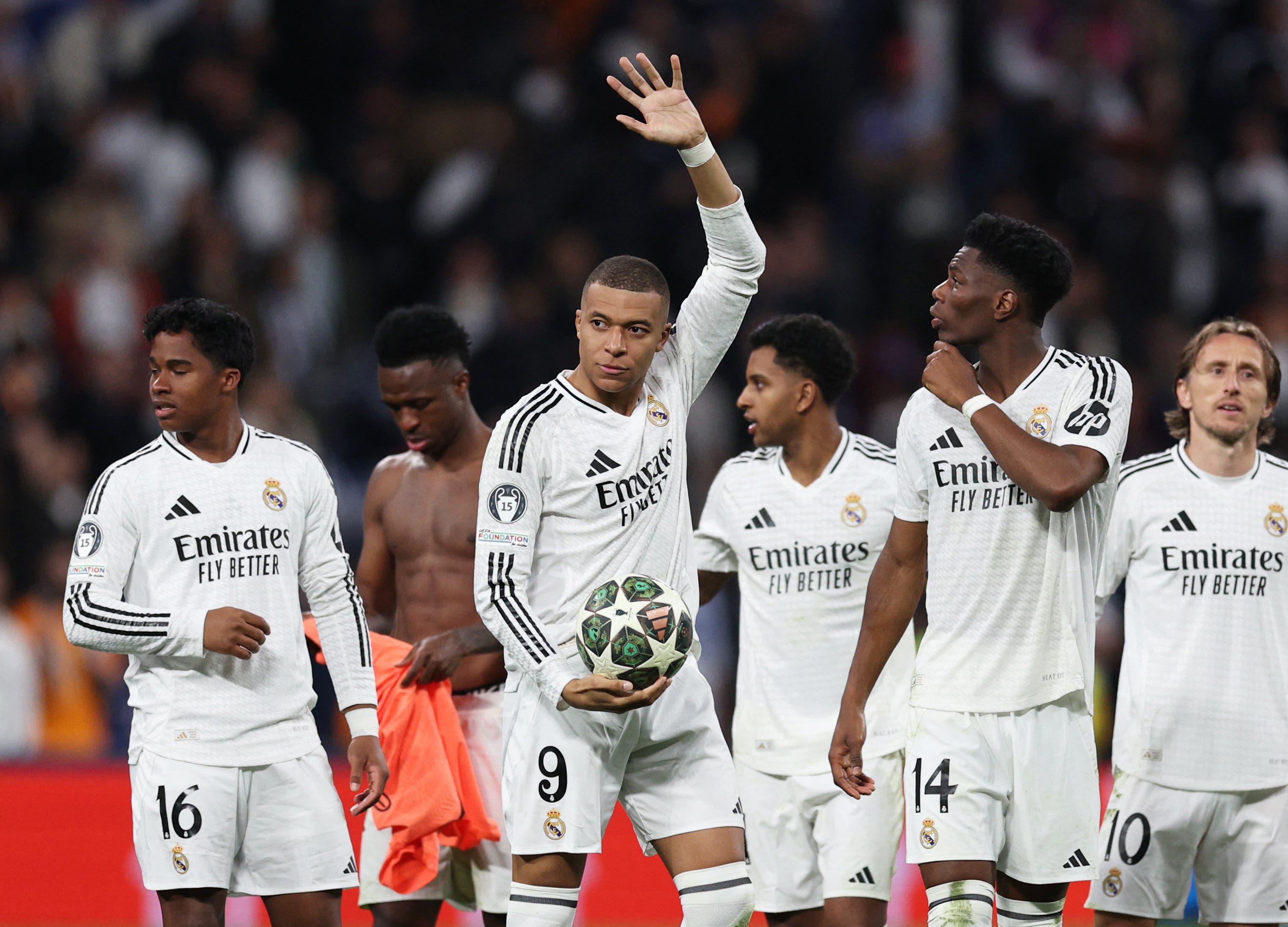 Real Madrid's Kylian Mbappe celebrates with Aurelien Tchouameni after the match while holding the match ball after scoring a hat-trick