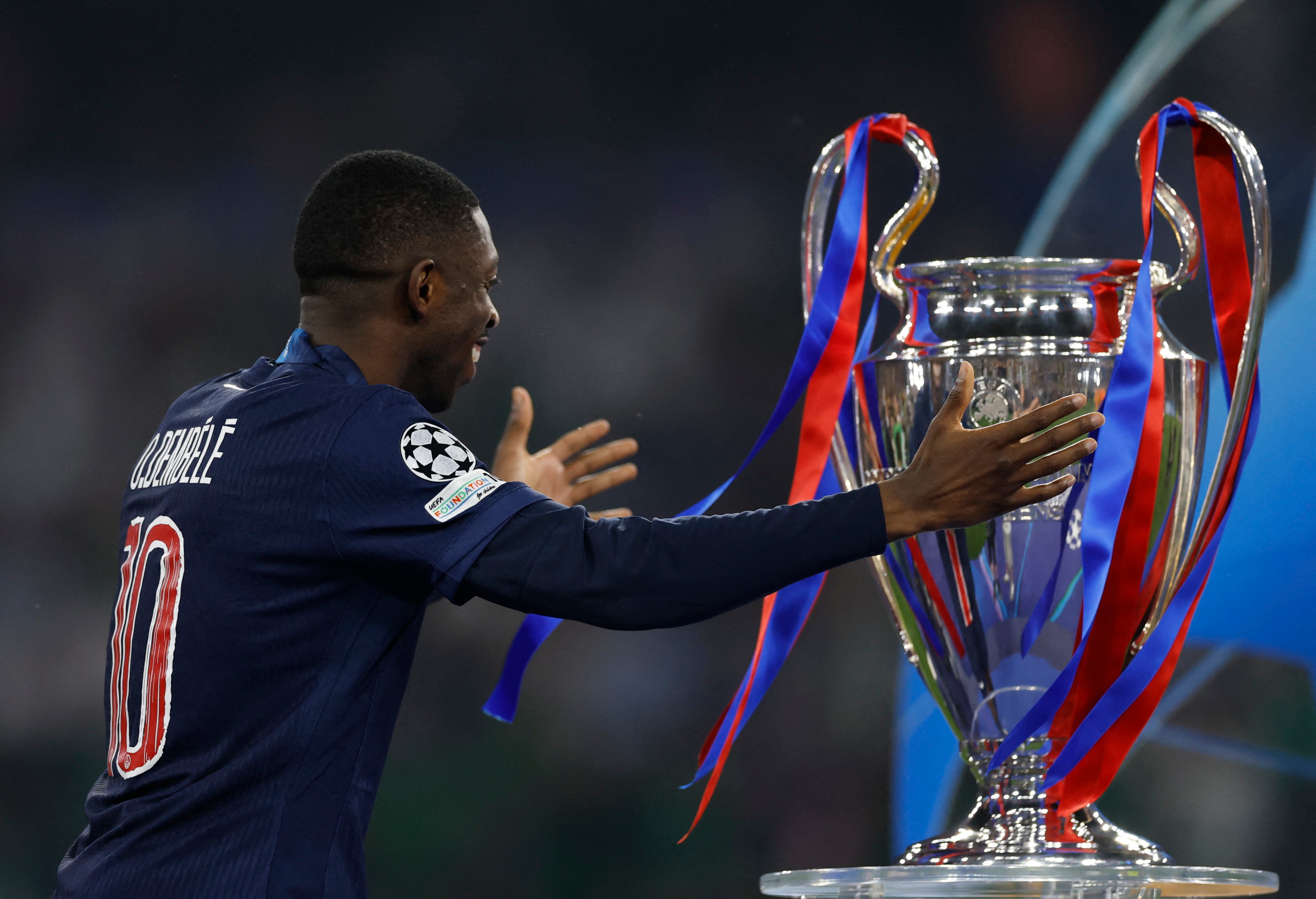 Paris St Germain's Ousmane Dembele with the trophy after collecting his winners medal 