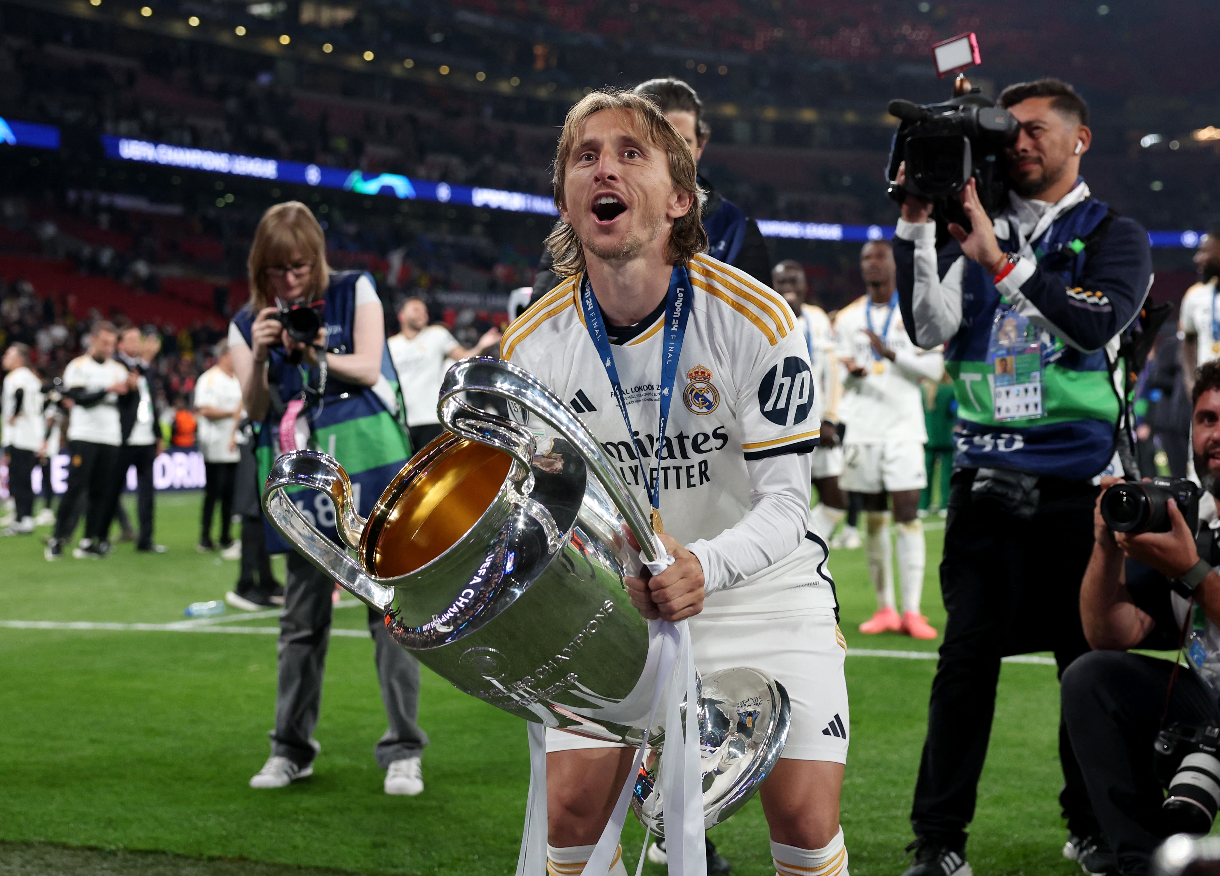 Real Madrid's Luka Modric celebrates with the trophy after winning the Champions League final 