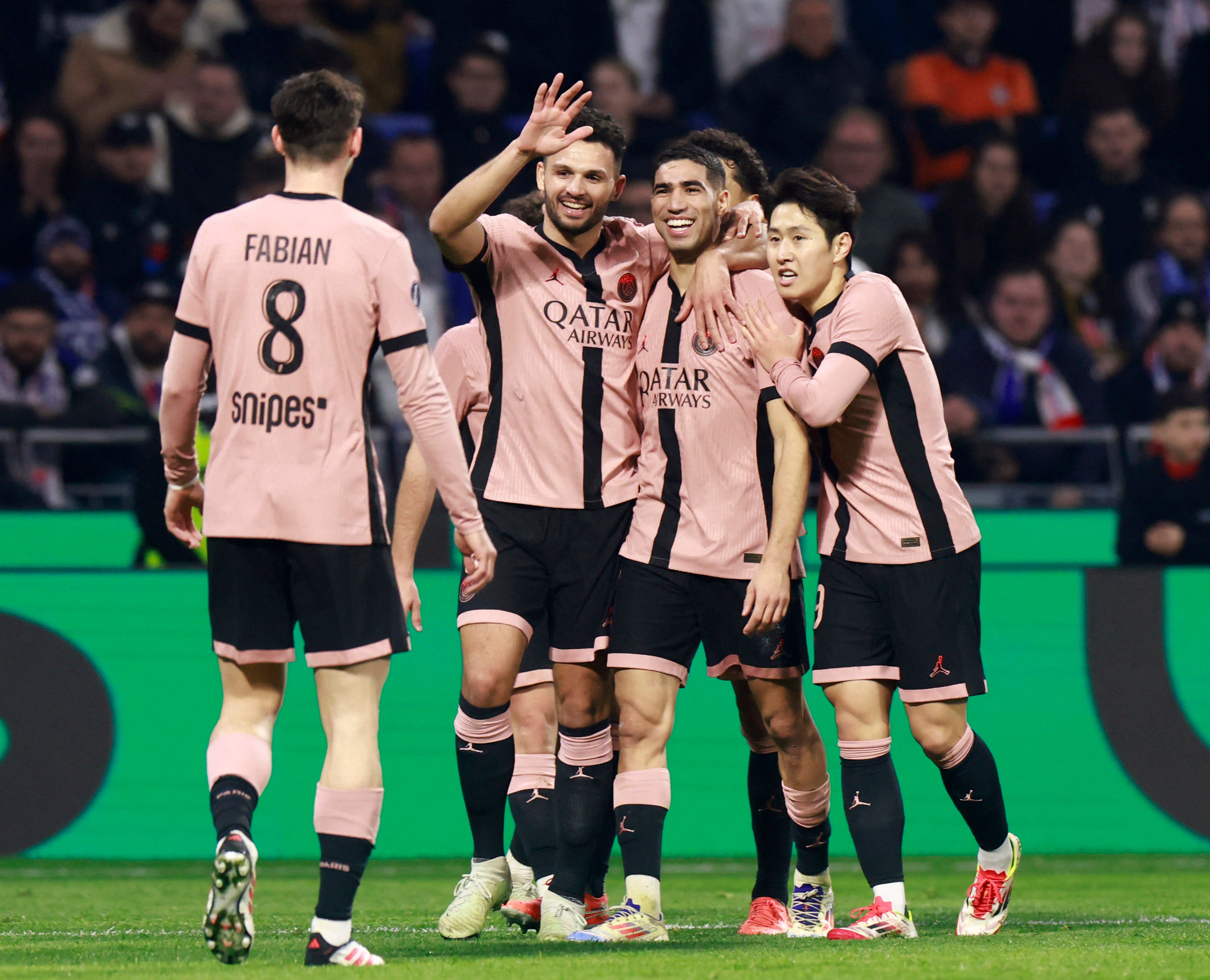 Paris St Germain's Achraf Hakimi celebrates scoring their third goal with teammates