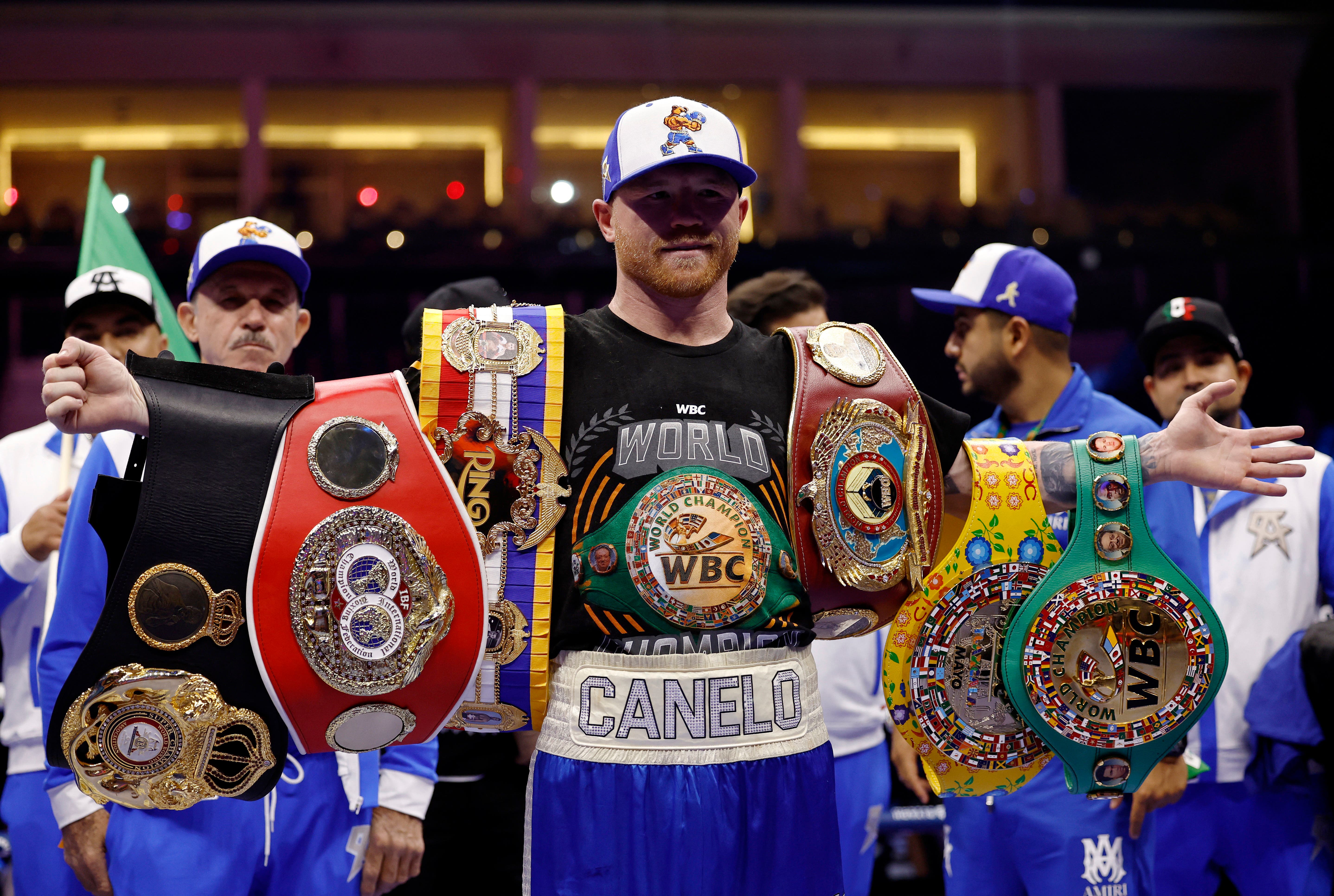 Boxing - Saul 'Canelo' Alvarez vs William Scull - Undisputed Super Middleweight Championship - ANB Arena, Riyadh, Saudi Arabia - May 3, 2025 Saul 'Canelo' Alvarez poses with his championship belts and celebrates after winning his super middleweight fight against William Scull REUTERS/Hamad I Mohammed