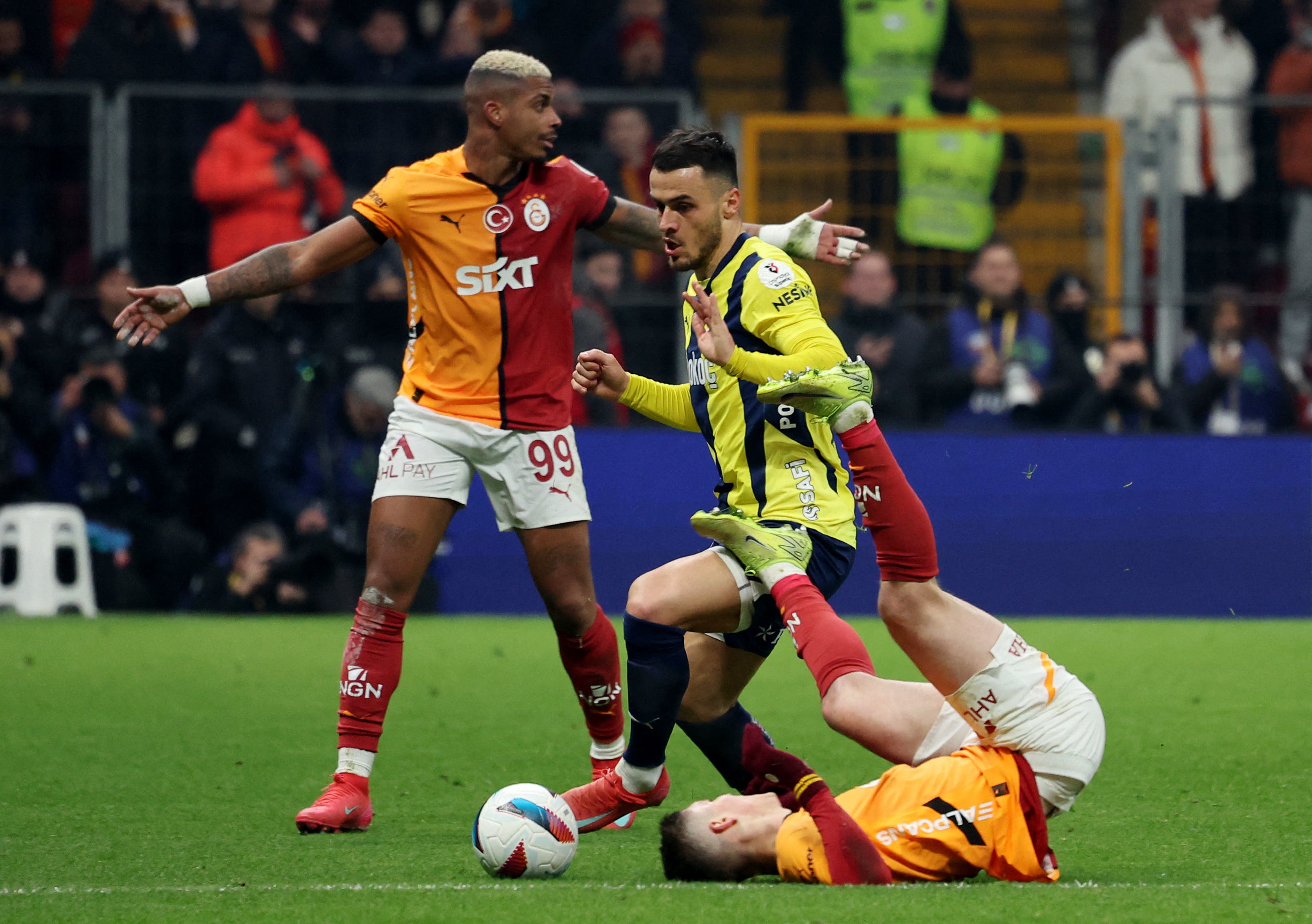  Galatasaray's Roland Sallai in action as he is tackled by Fenerbahce's Filip Kostic