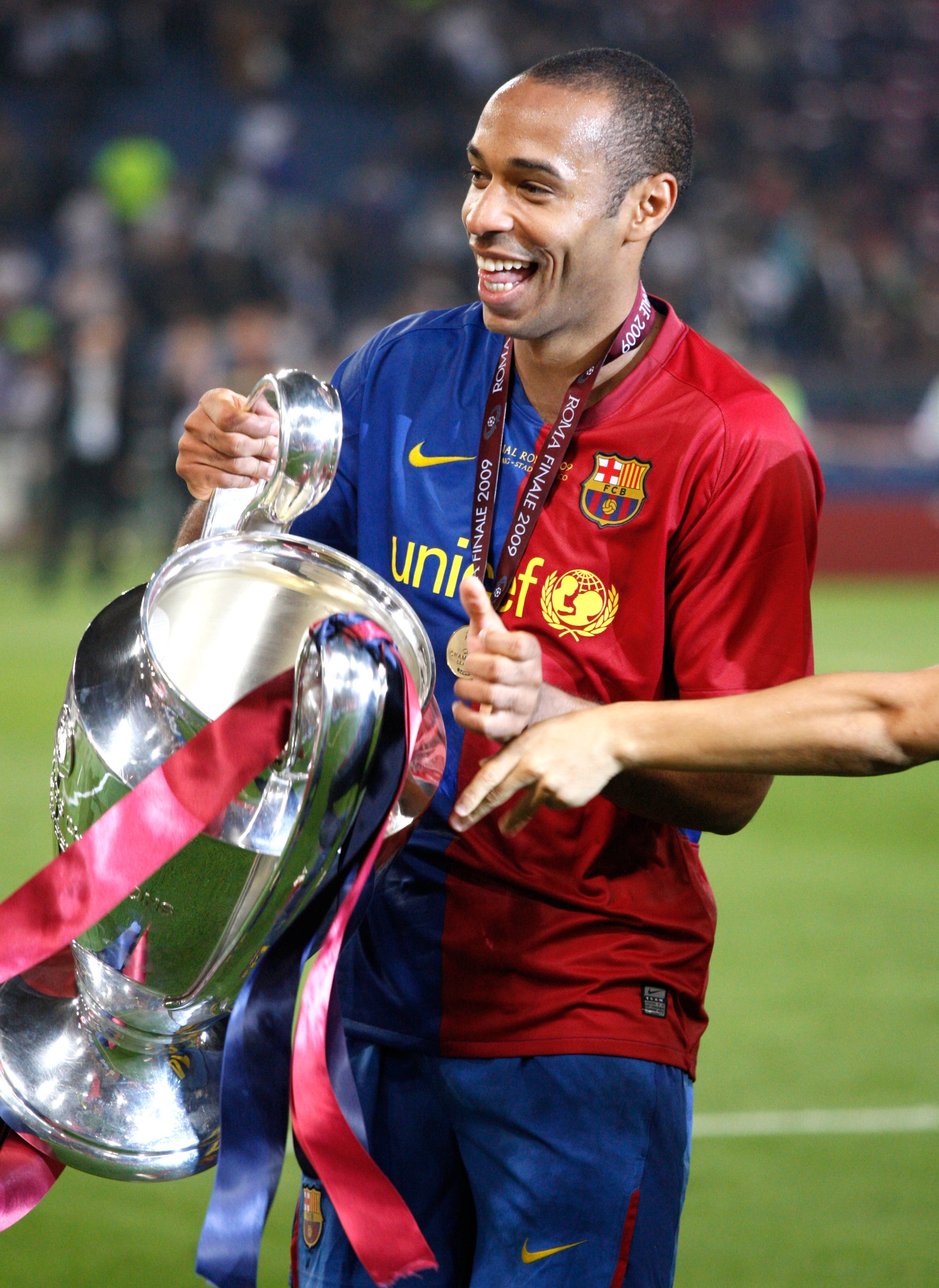 Barcelona's Thierry Henry celebrates victory with the trophy 