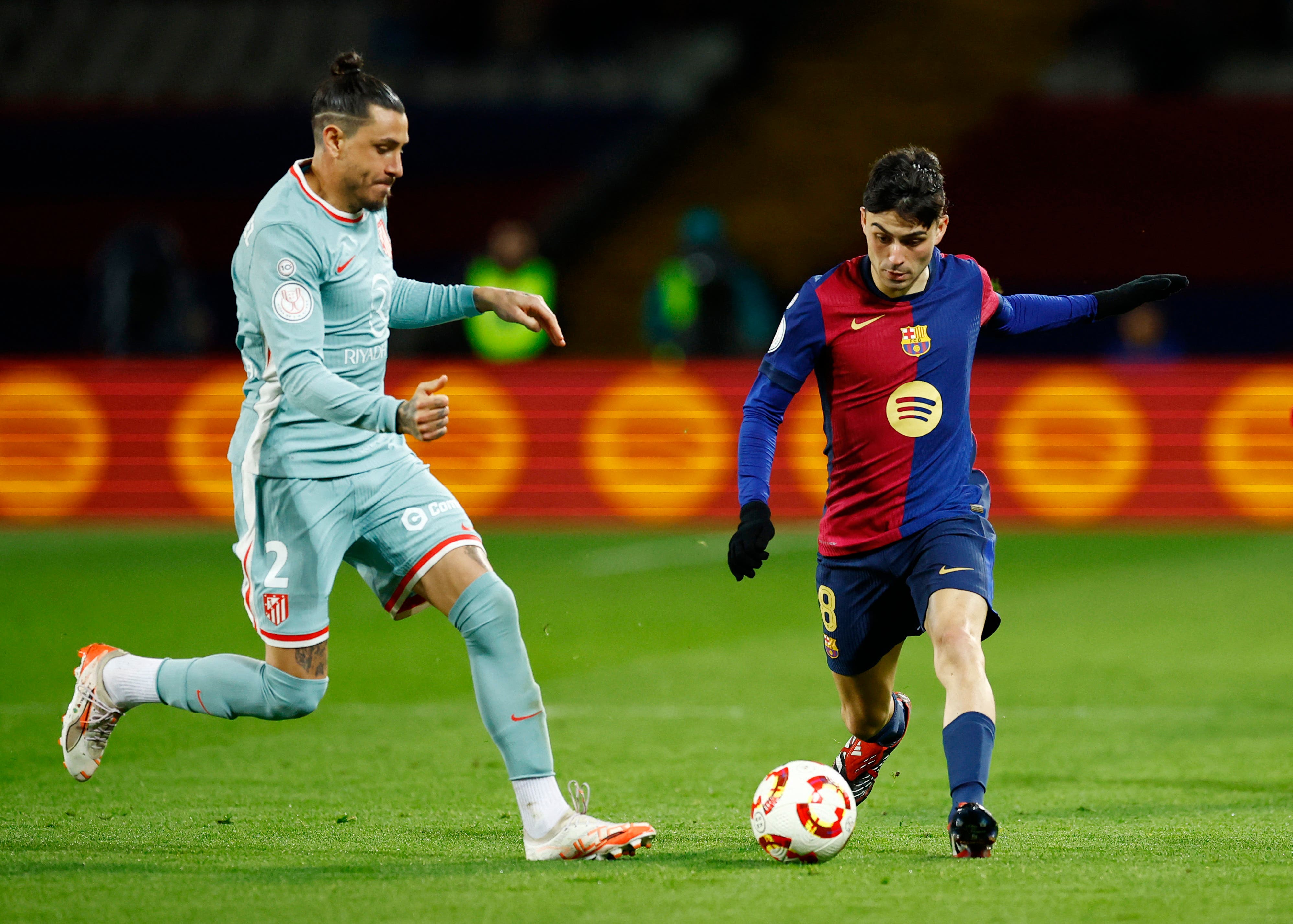 Soccer Football - Copa del Rey - Semi Final - First Leg - FC Barcelona v Atletico Madrid - Estadi Olimpic Lluis Companys, Barcelona, Spain - February 25, 2025 FC Barcelona's Pedri in action with Atletico Madrid's Jose Maria Gimenez REUTERS/Albert Gea