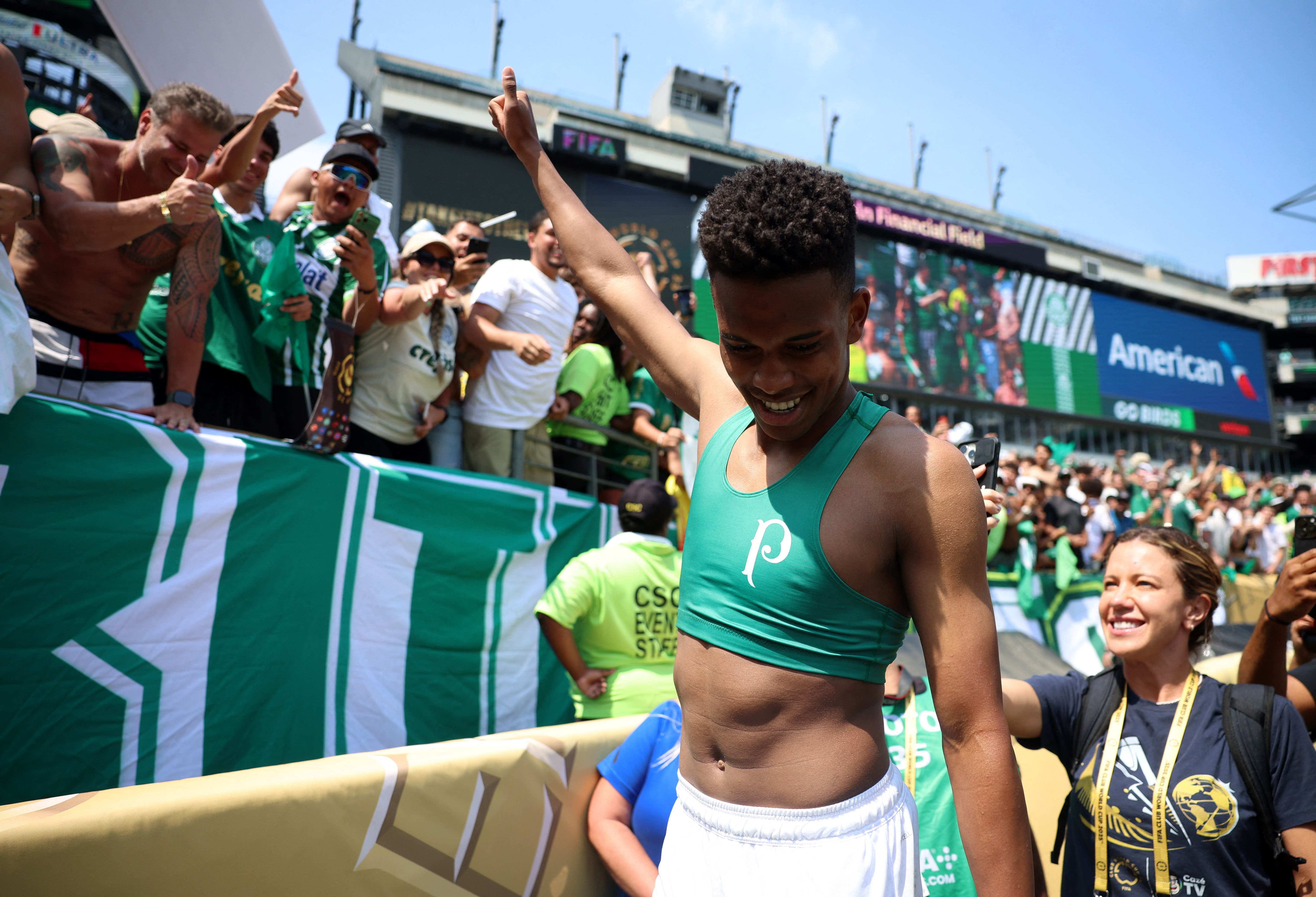 Palmeiras' Estevao celebrates with fans after the match