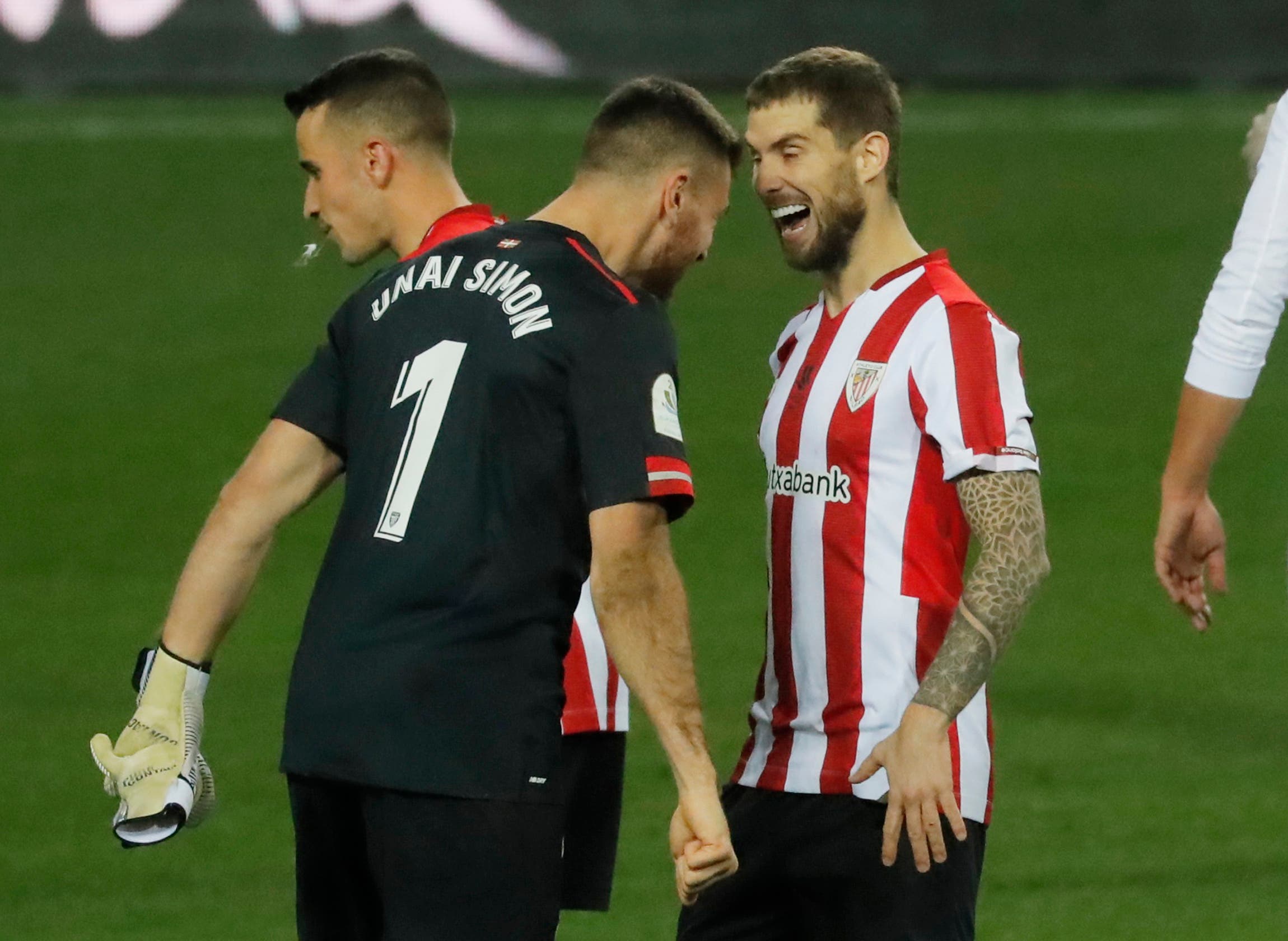 Athletic Bilbao's Inigo Martinez celebrates with Unai Simon in 2021