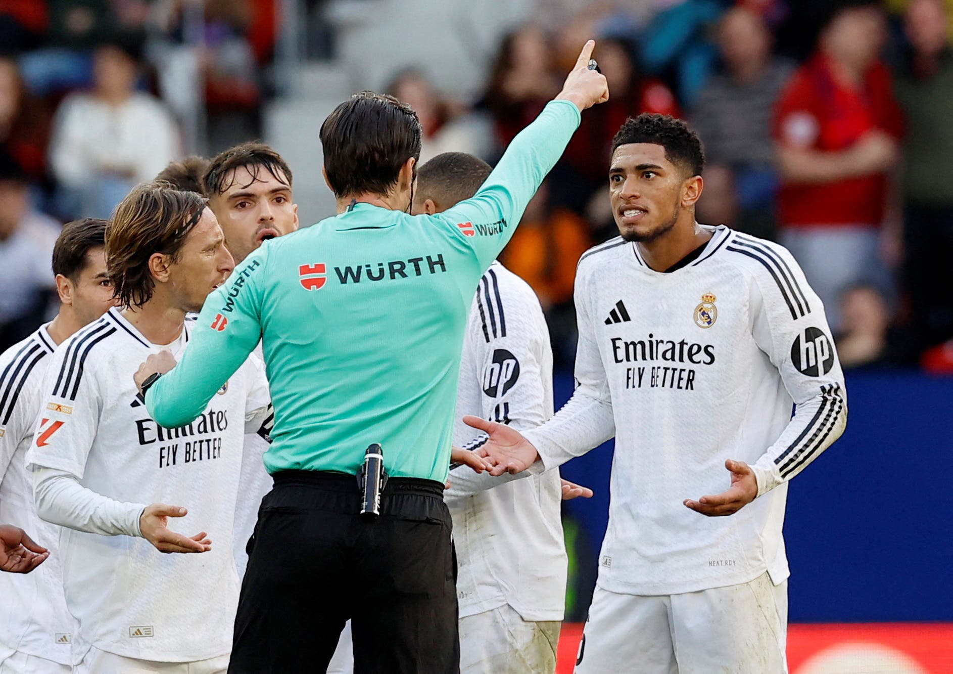 Real Madrid's Jude Bellingham reacts after being shown a red card by referee Jose Munuera