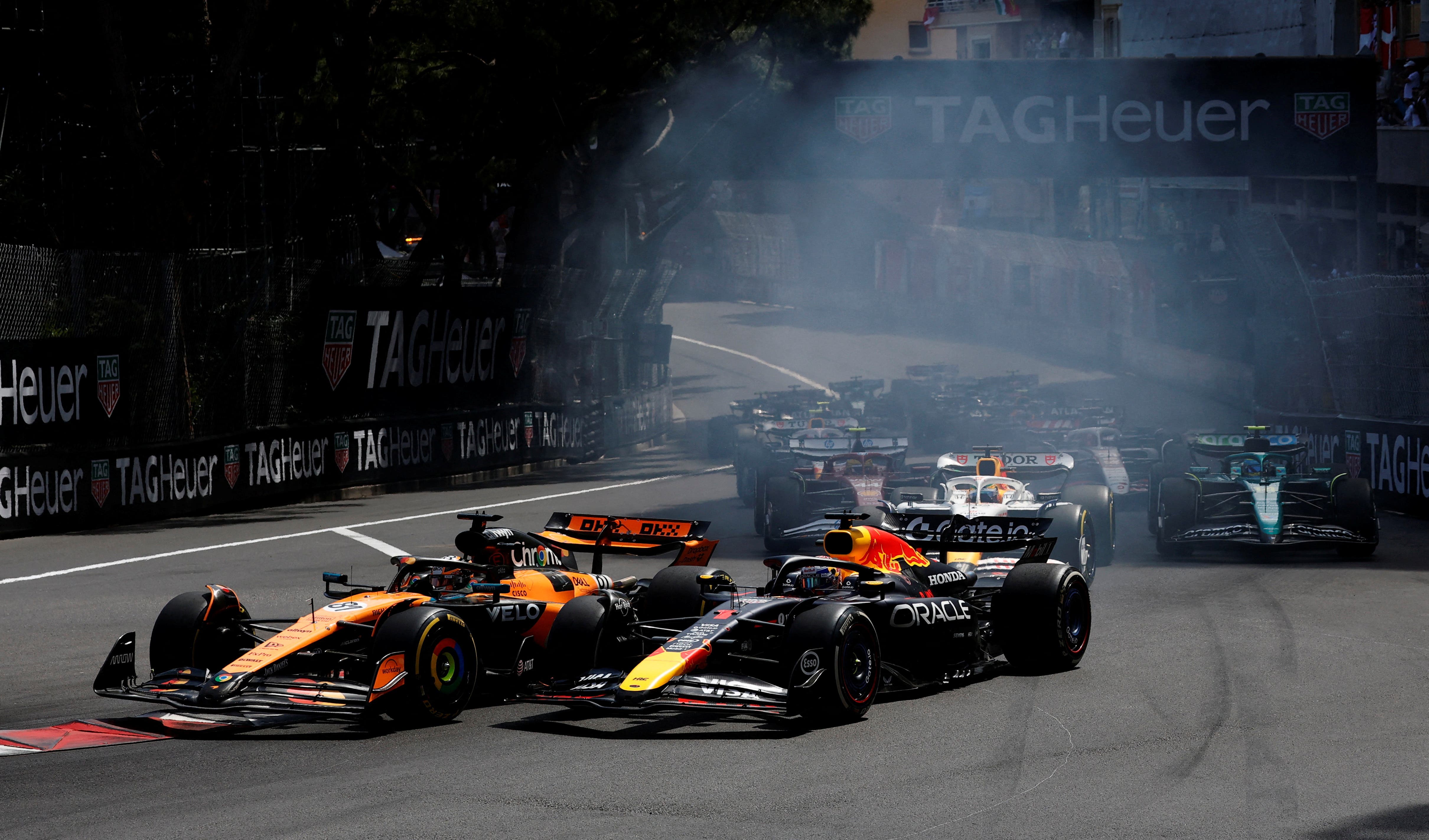 Max Verstappen for Red Bull and Oscar Piastri for McLaren racing each other in the 2025 Monaco Grand Prix.