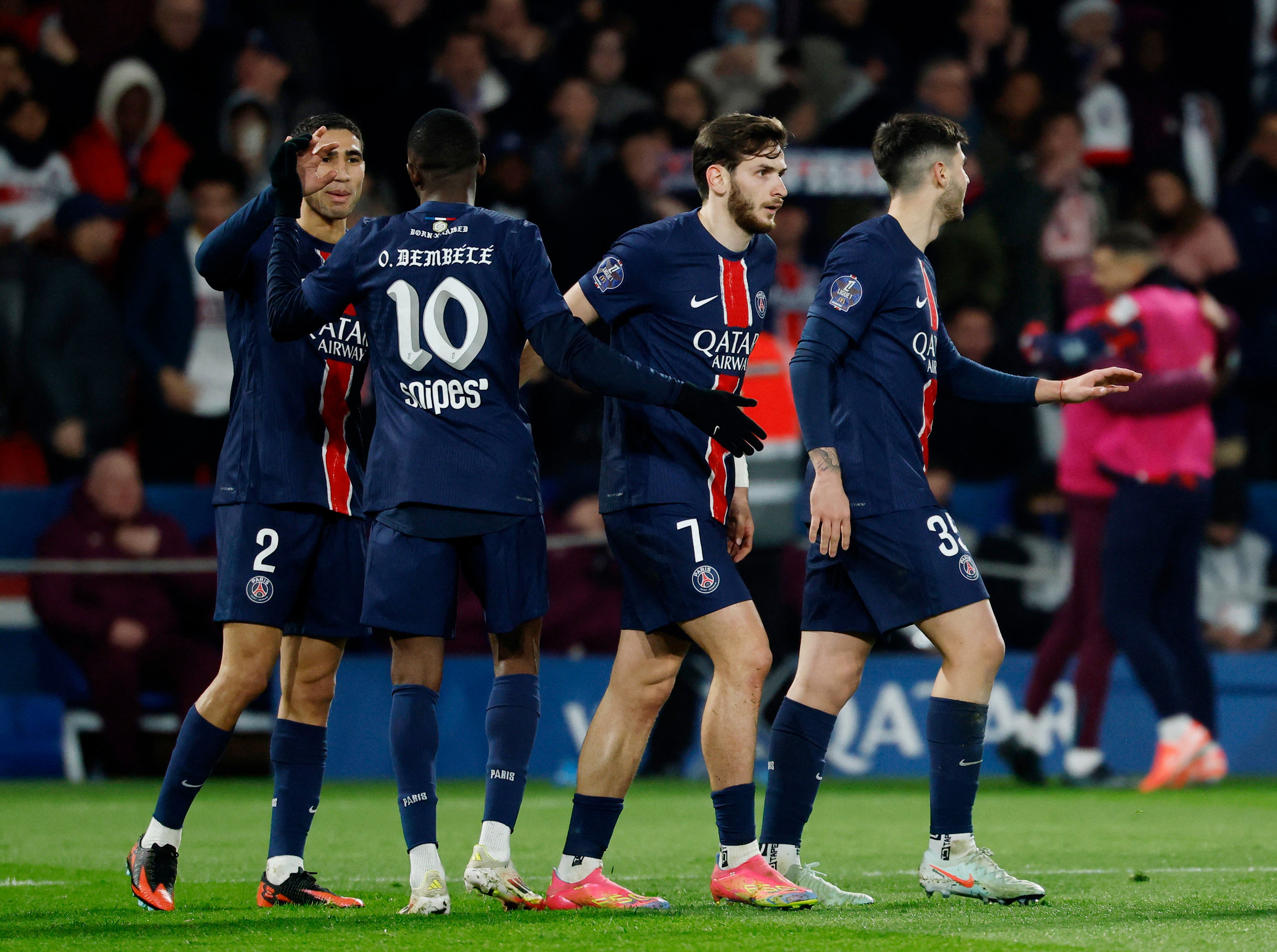 Paris St Germain's Khvicha Kvaratskhelia, Achraf Hakimi and Ousmane Dembele celebrate their third goal scored by Olympique de Marseille'