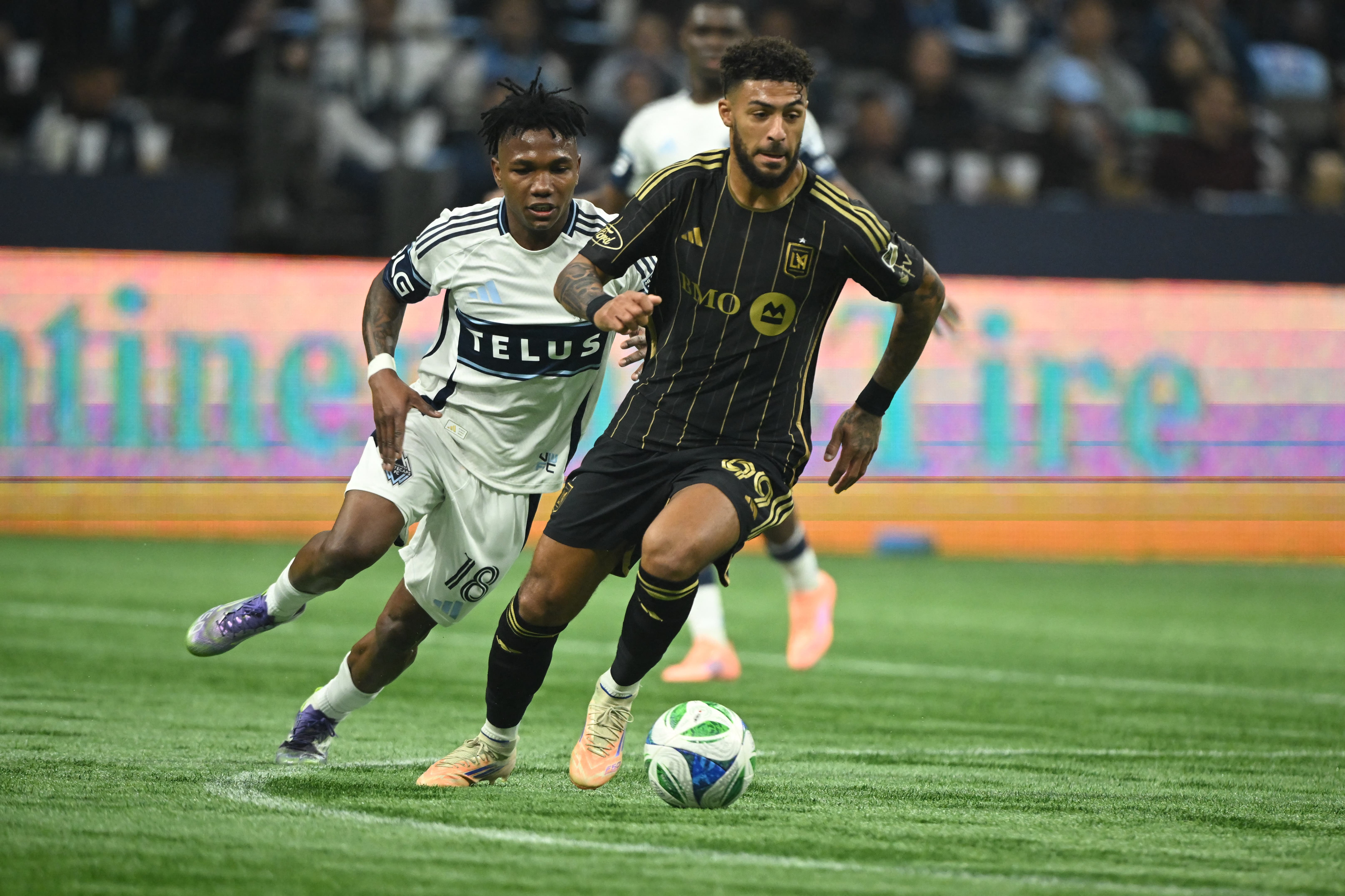 Nov 22, 2025; Vancouver, British Columbia, CAN; Los Angeles FC forward Denis Bouanga (99) controls the ball against Vancouver Whitecaps FC defender Edier Ocampo (18) during the first half at BC Place. Mandatory Credit: Anne-Marie Sorvin-Imagn Images
