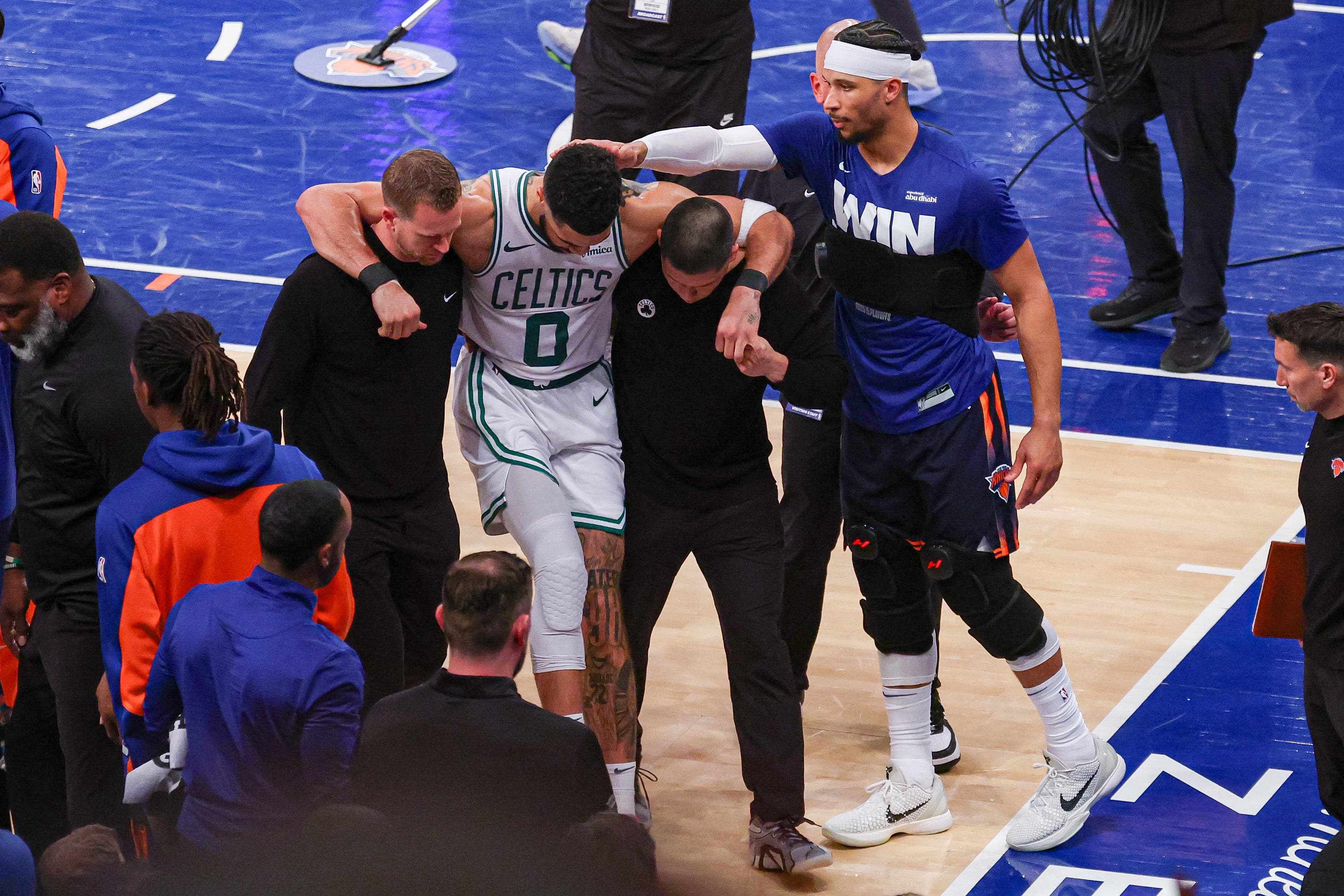 Boston Celtics forward Jayson Tatum (0) is helped off the court by after an injury 
