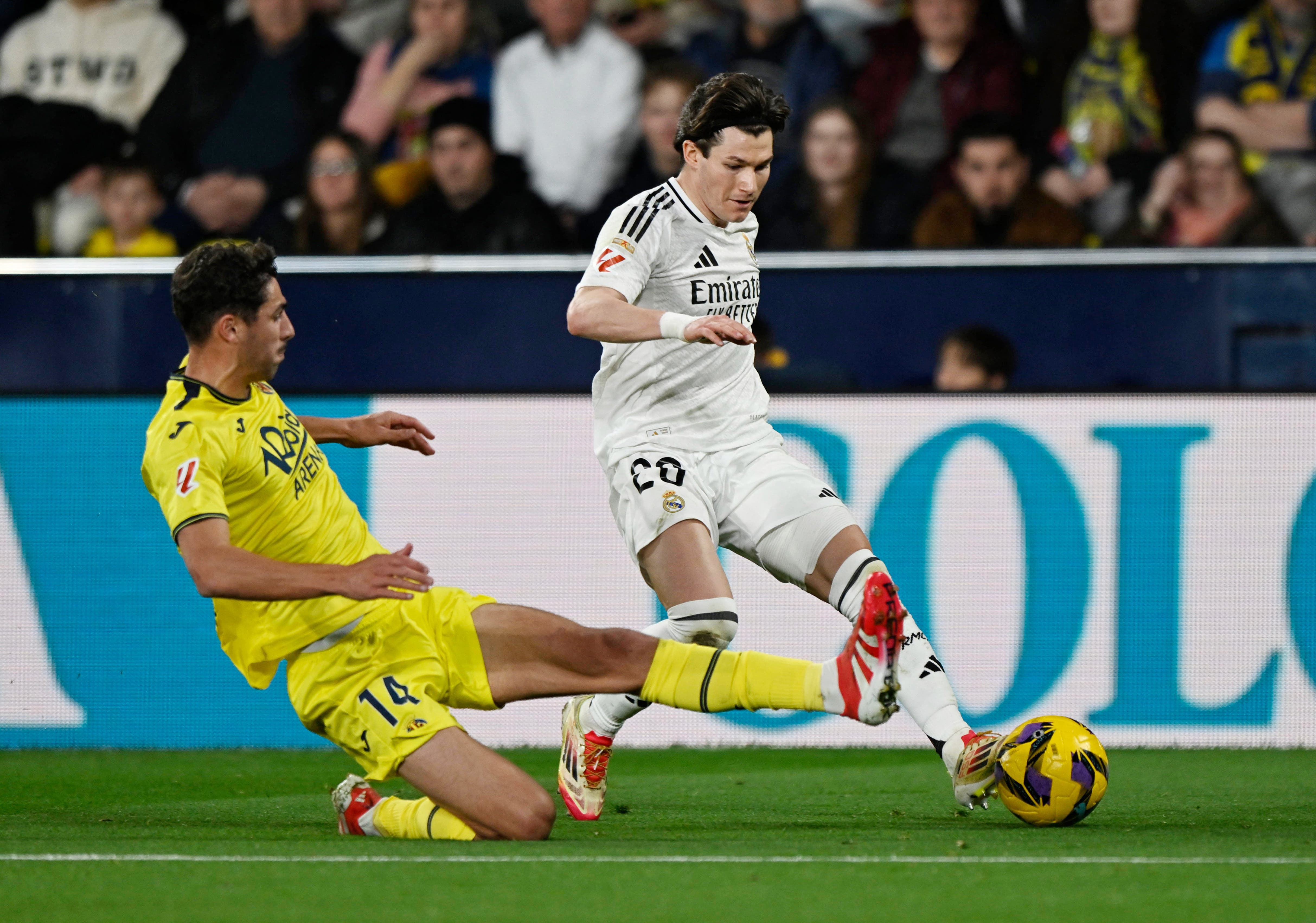 Real Madrid's Fran Garcia in action with Villarreal's Santi Comesana