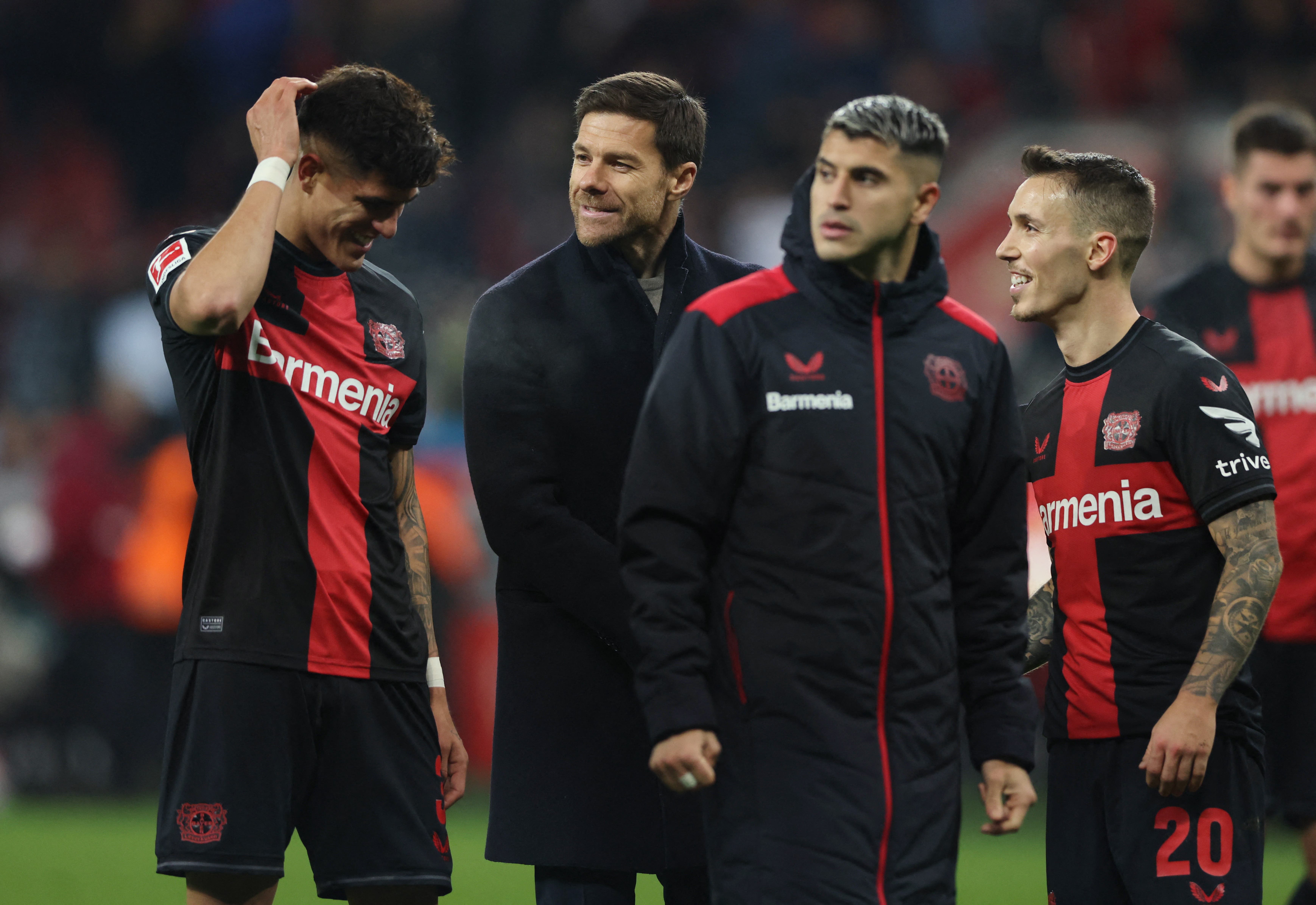 Bayer Leverkusen coach Xabi Alonso, Alejandro Grimaldo and Piero Hincapie celebrate after the match 