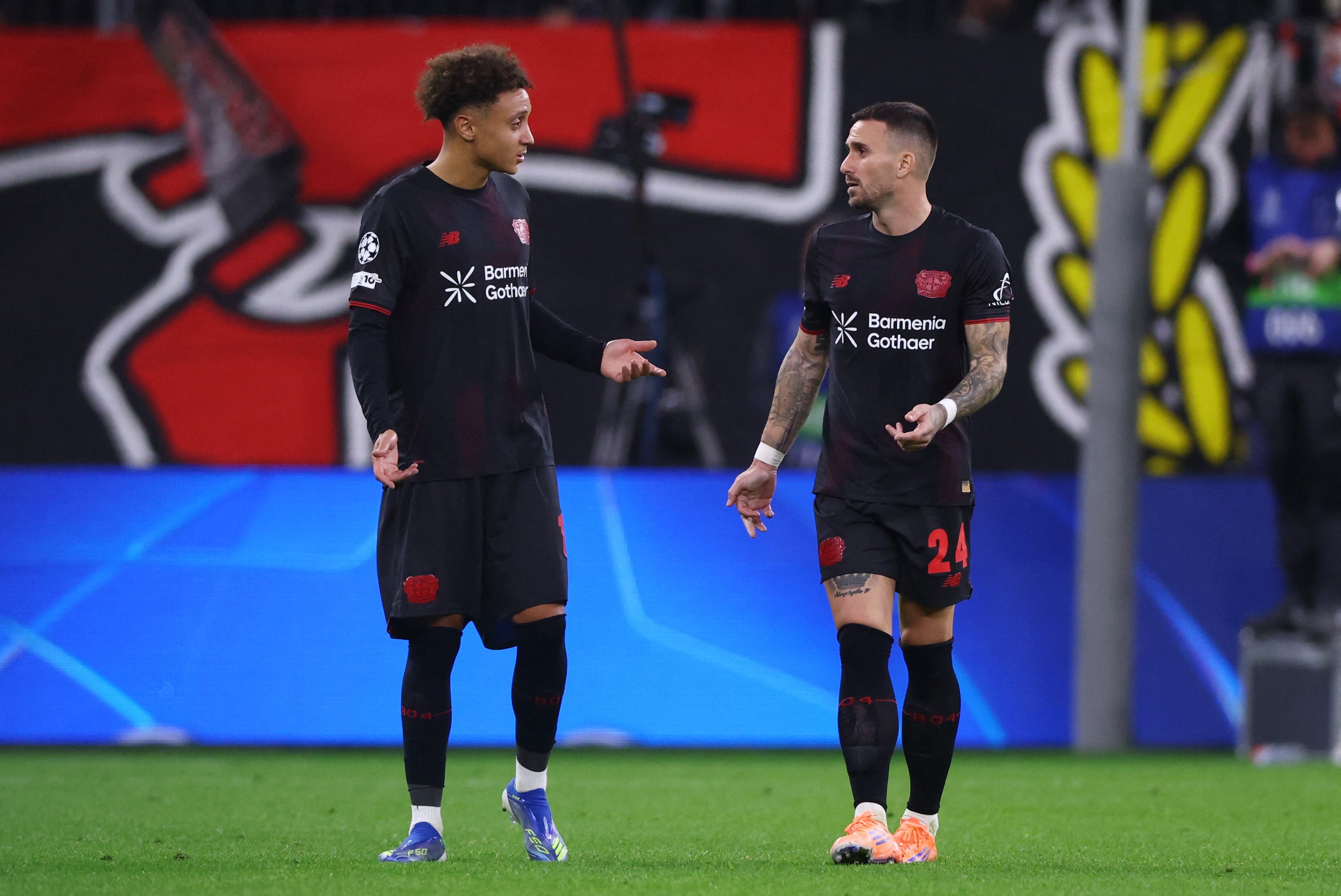 Soccer Football - UEFA Champions League - Bayer Leverkusen v Paris St Germain - BayArena, Leverkusen, Germany - October 21, 2025 Bayer Leverkusen's Eliesse Ben Seghir reacts with Aleix Garcia after the match REUTERS/Thilo Schmuelgen